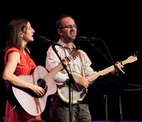 two people playing the guitar