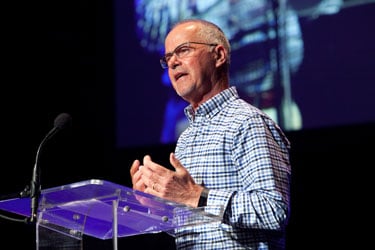 man speaking at podium