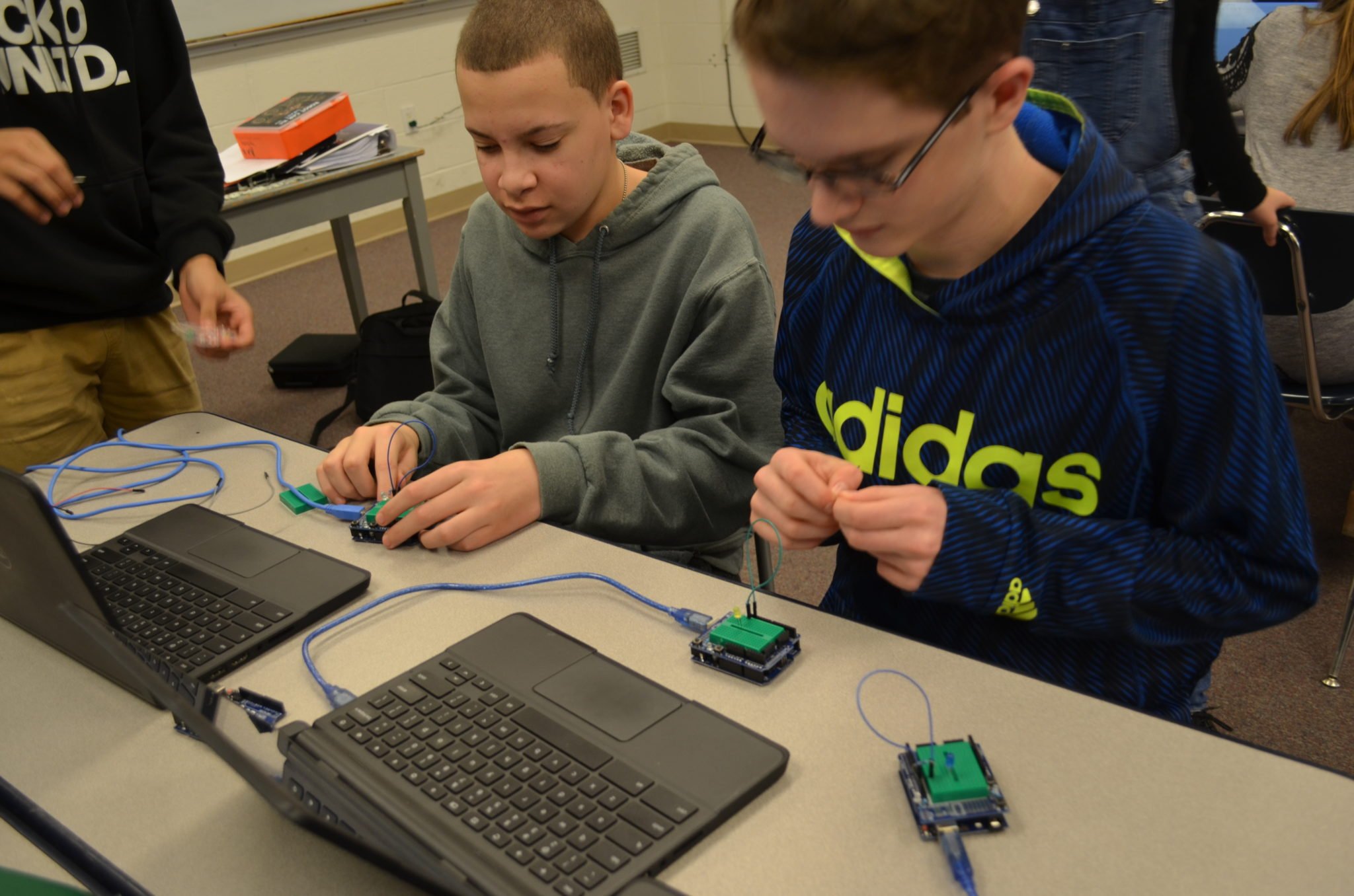 students working on programming robots