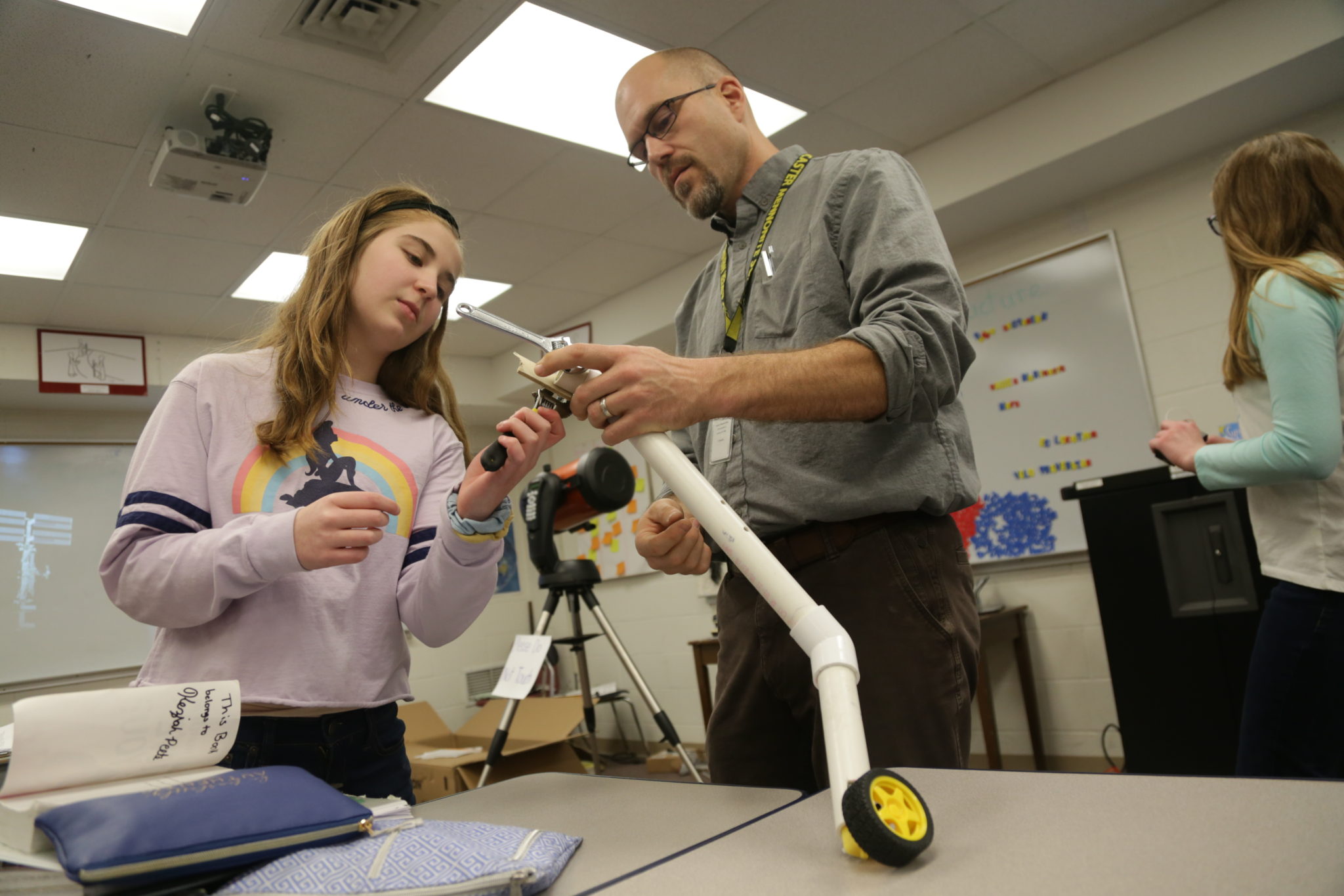 teacher and student working on robots