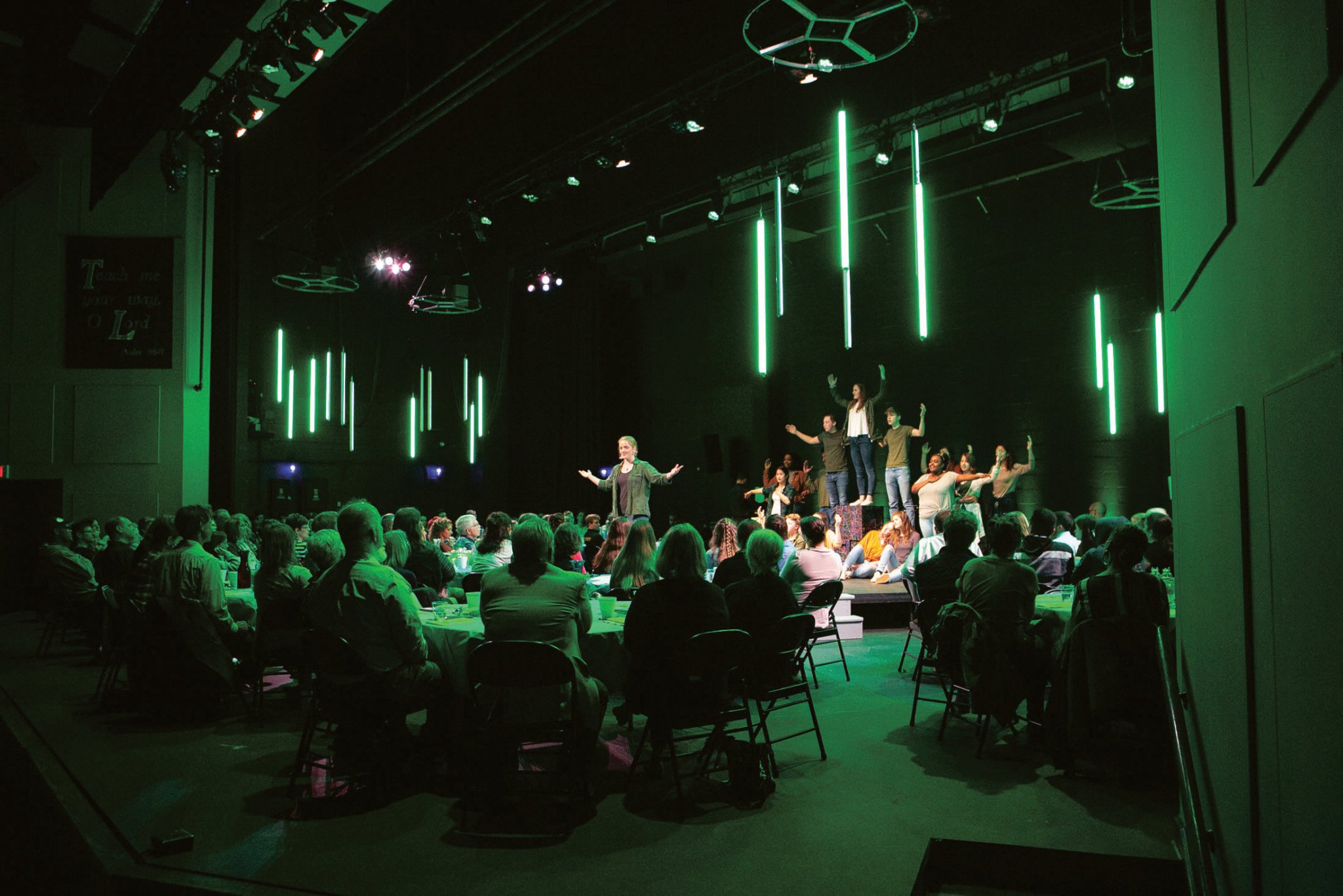 people gathered in a room for a performance