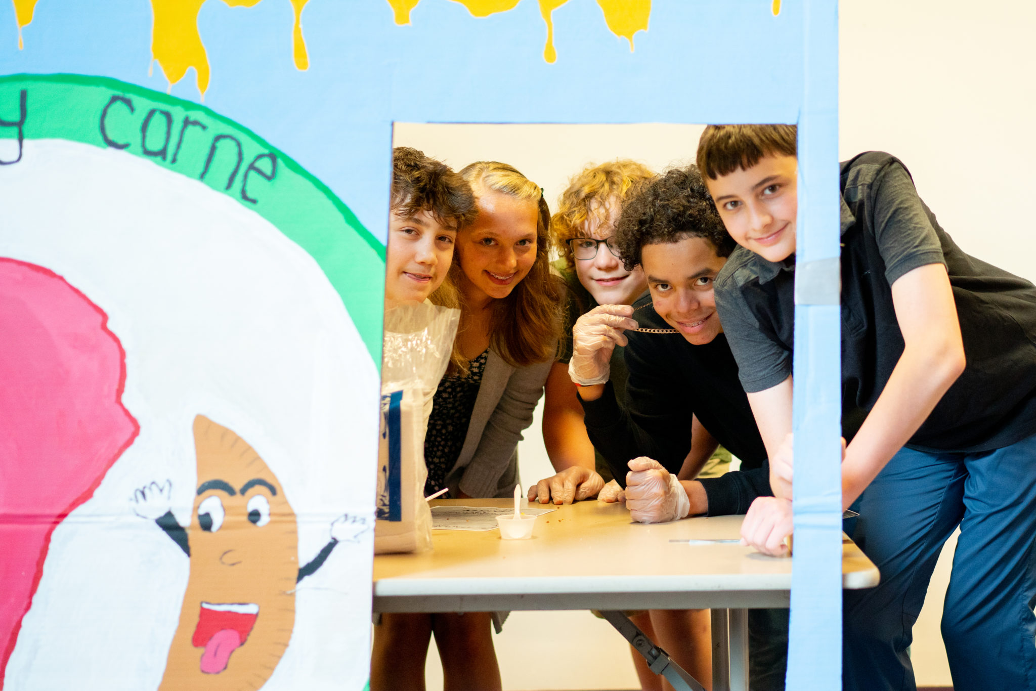 students posing with banners