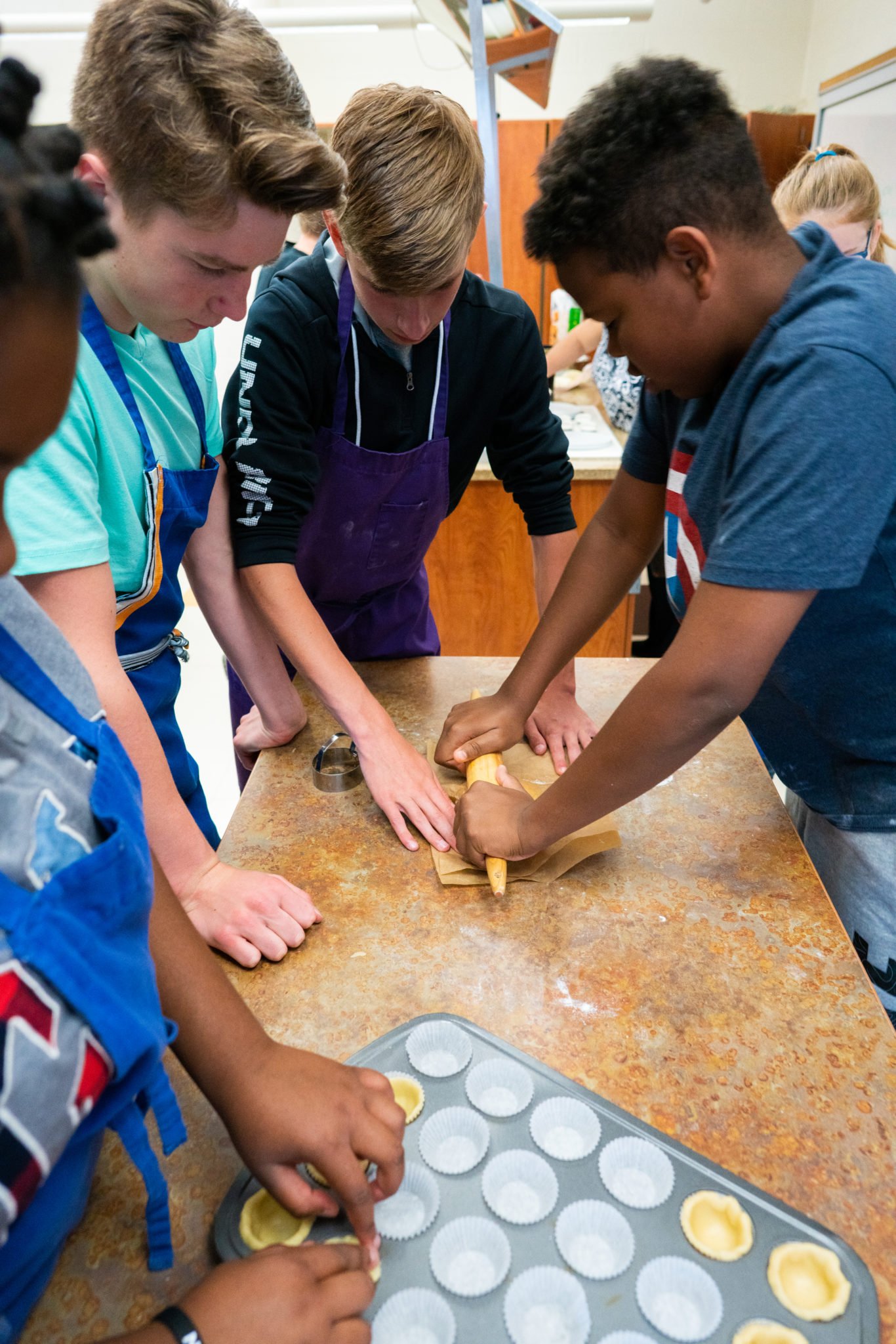 students working on cupcakes together