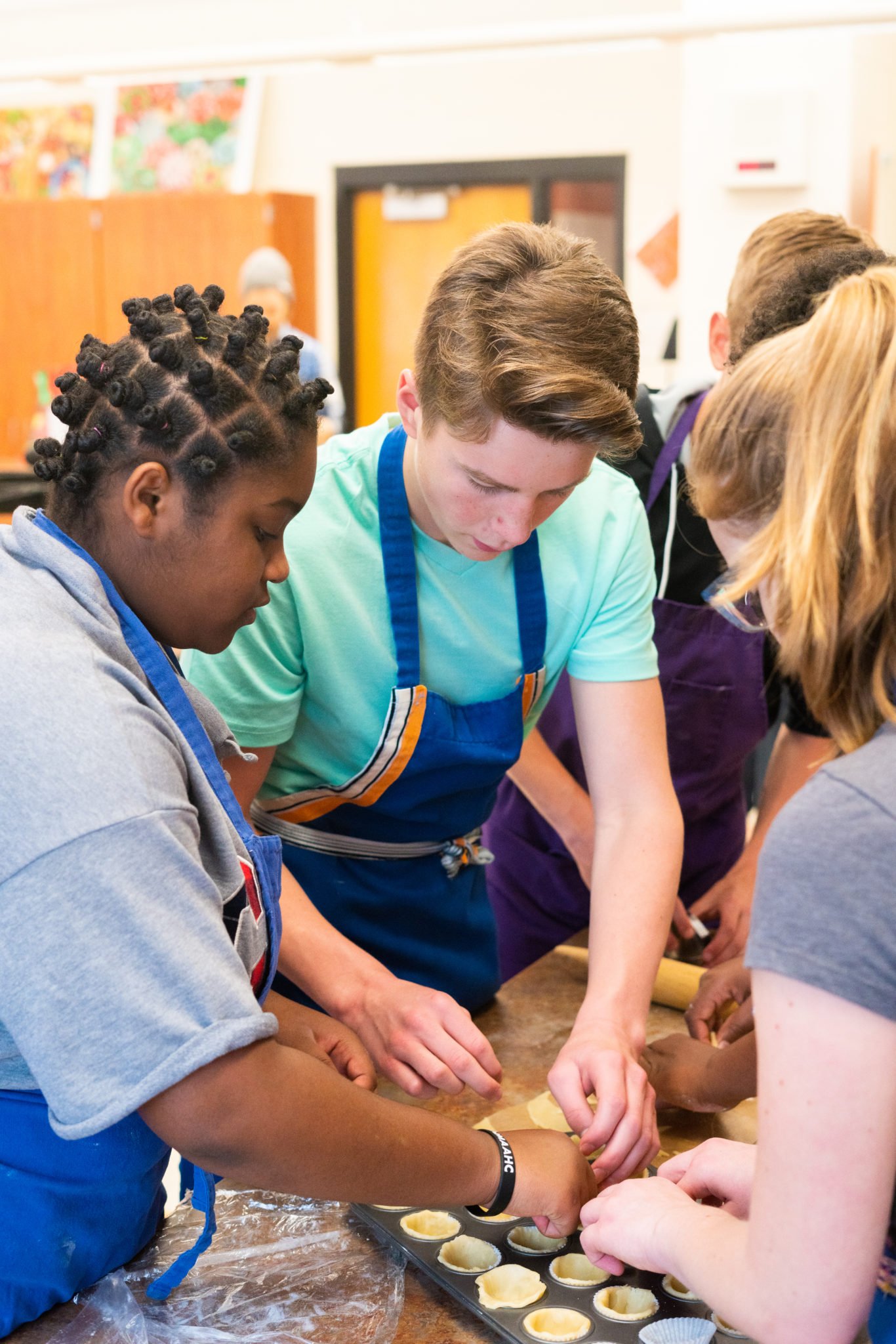 students working on cupcakes together