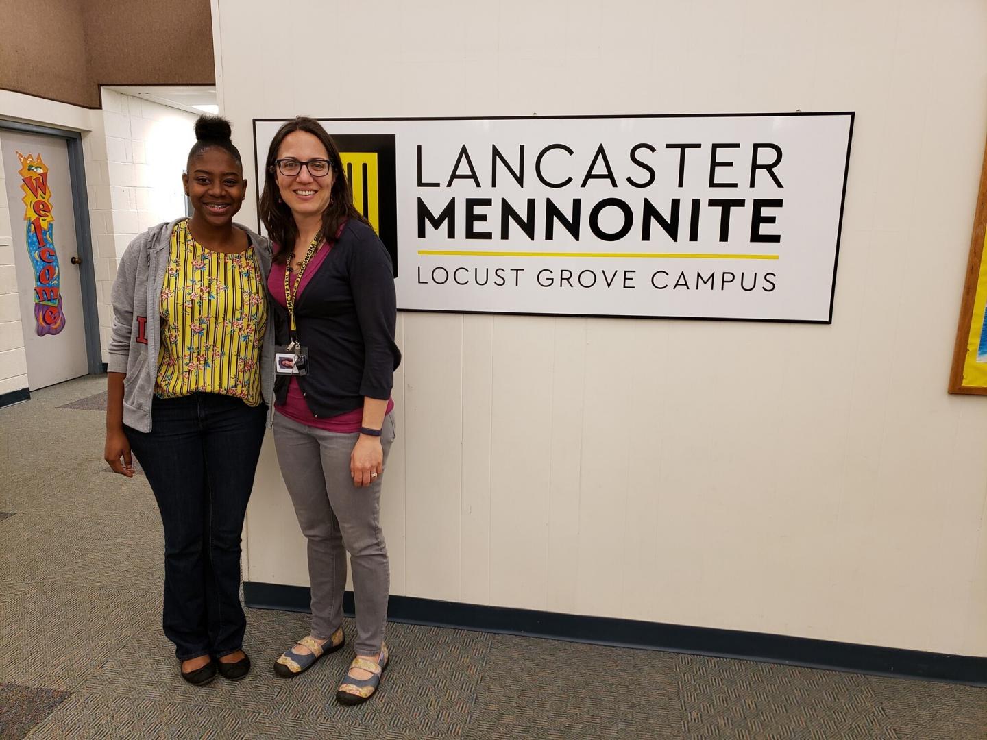 Carol with LM Teacher, Jenn Esbenshade by the school sign