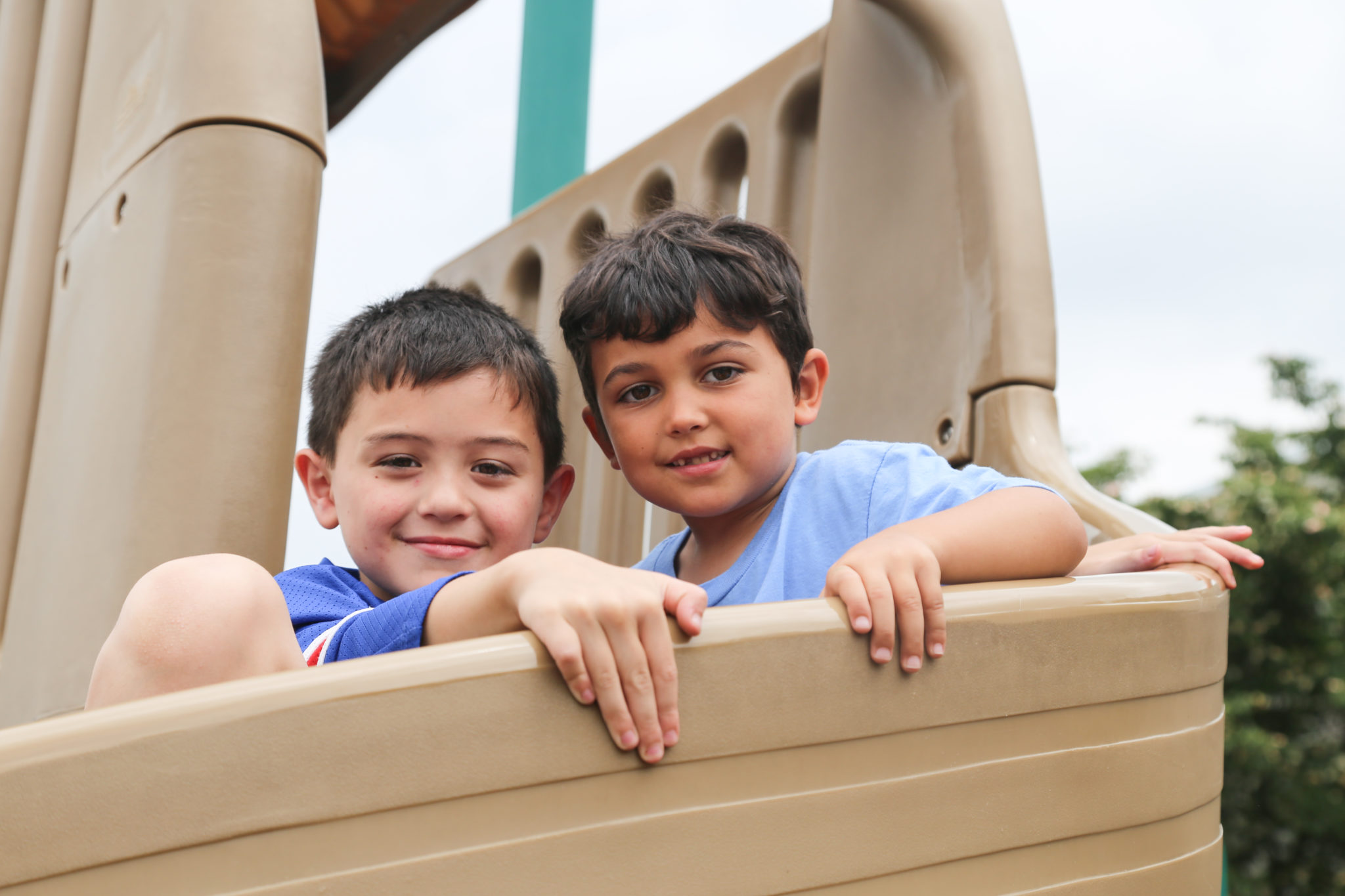 students sitting on slide smiling