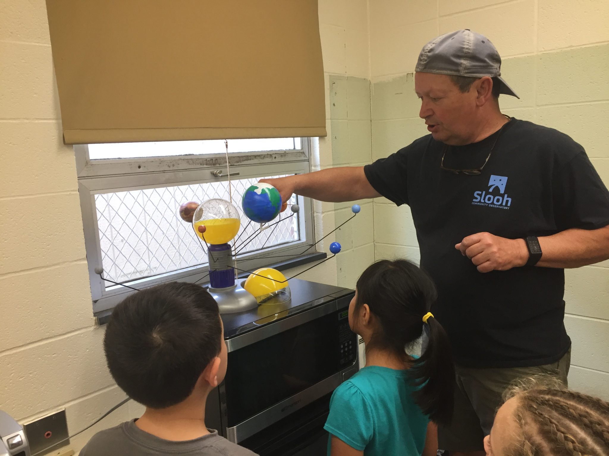 Students gathered around solar system module