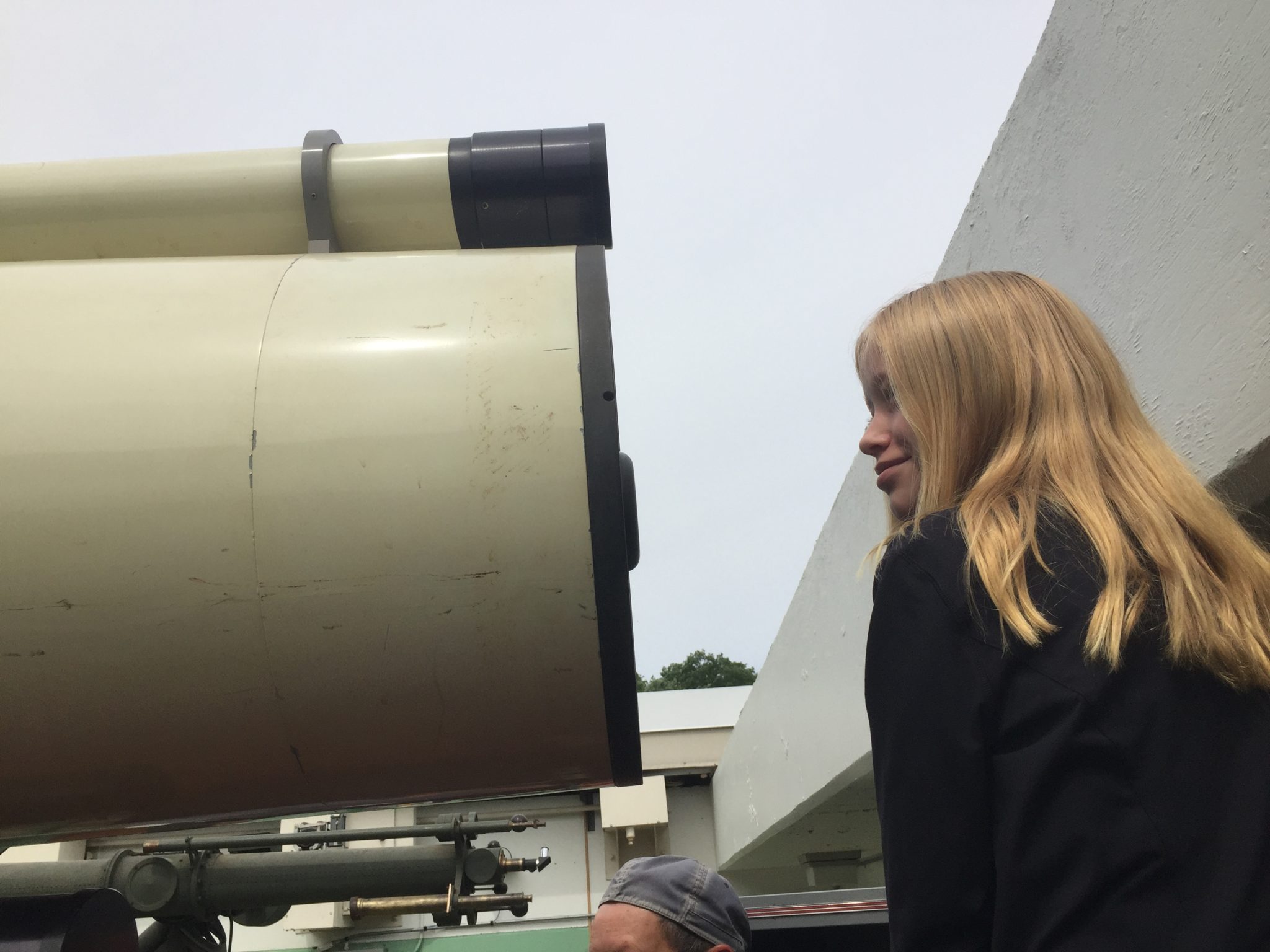 student looking through telescope