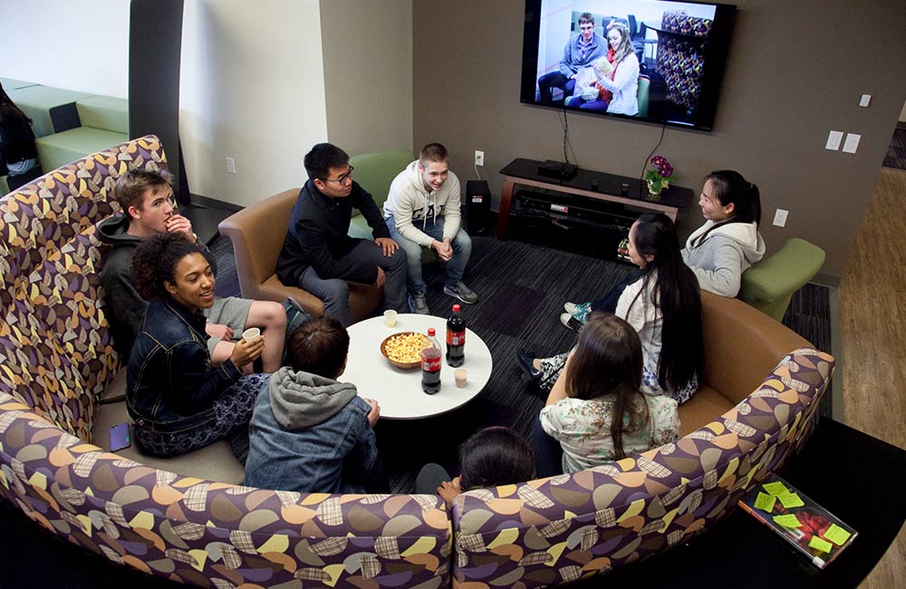 students conversing in dorm great hall