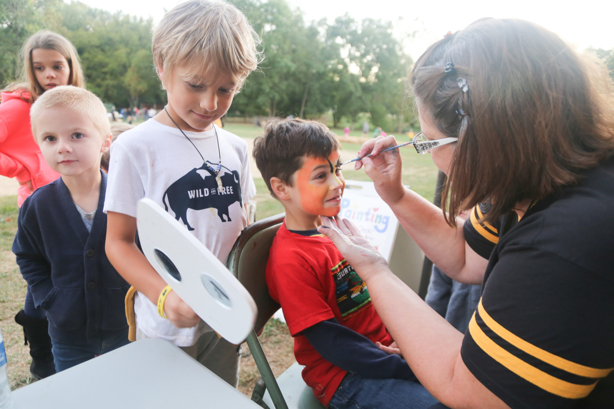 face painting done by Mrs. Horst at homecoming, students getting tiger faces