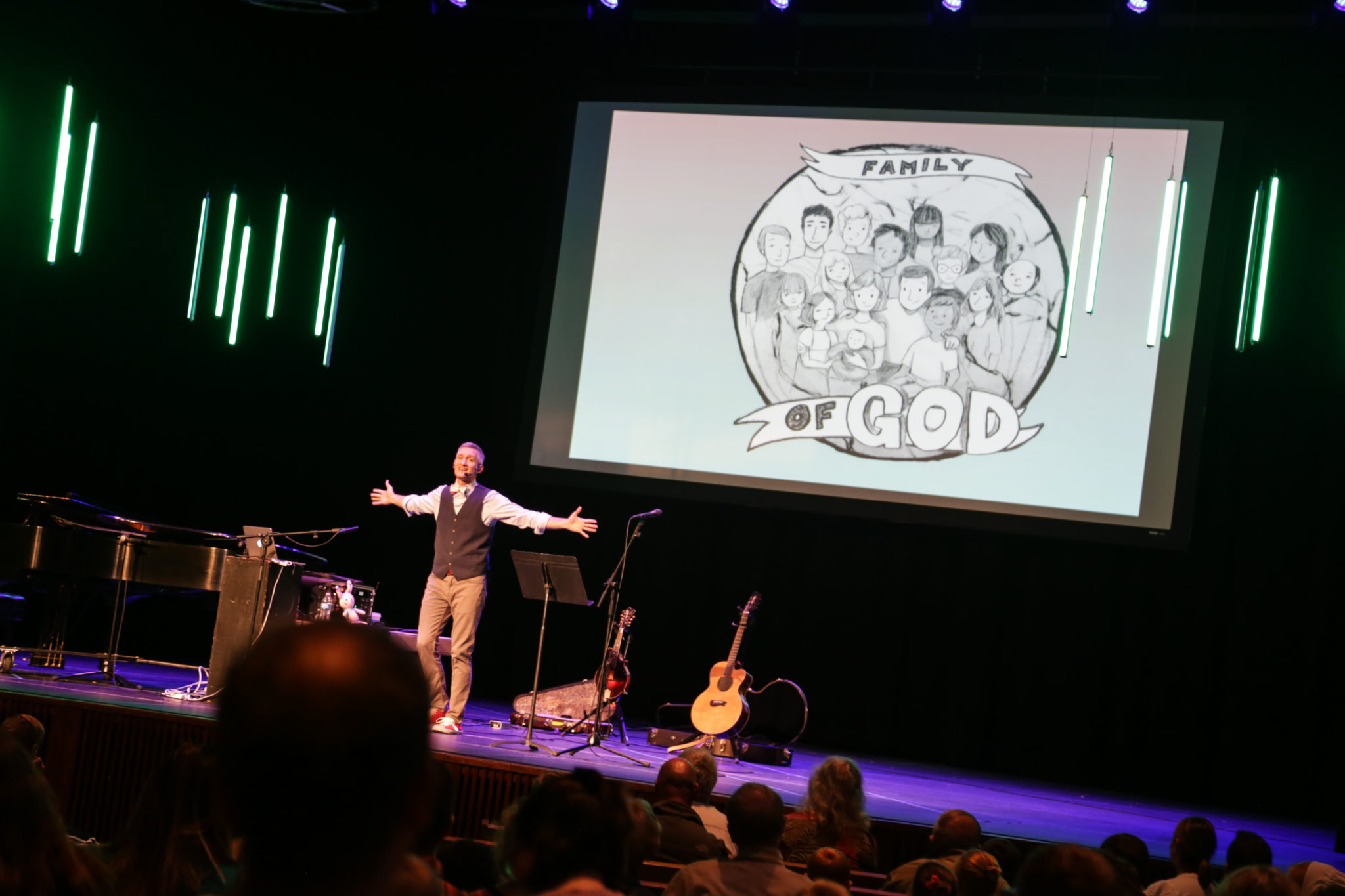 Speaker for chapel, family of god display on screen on stage