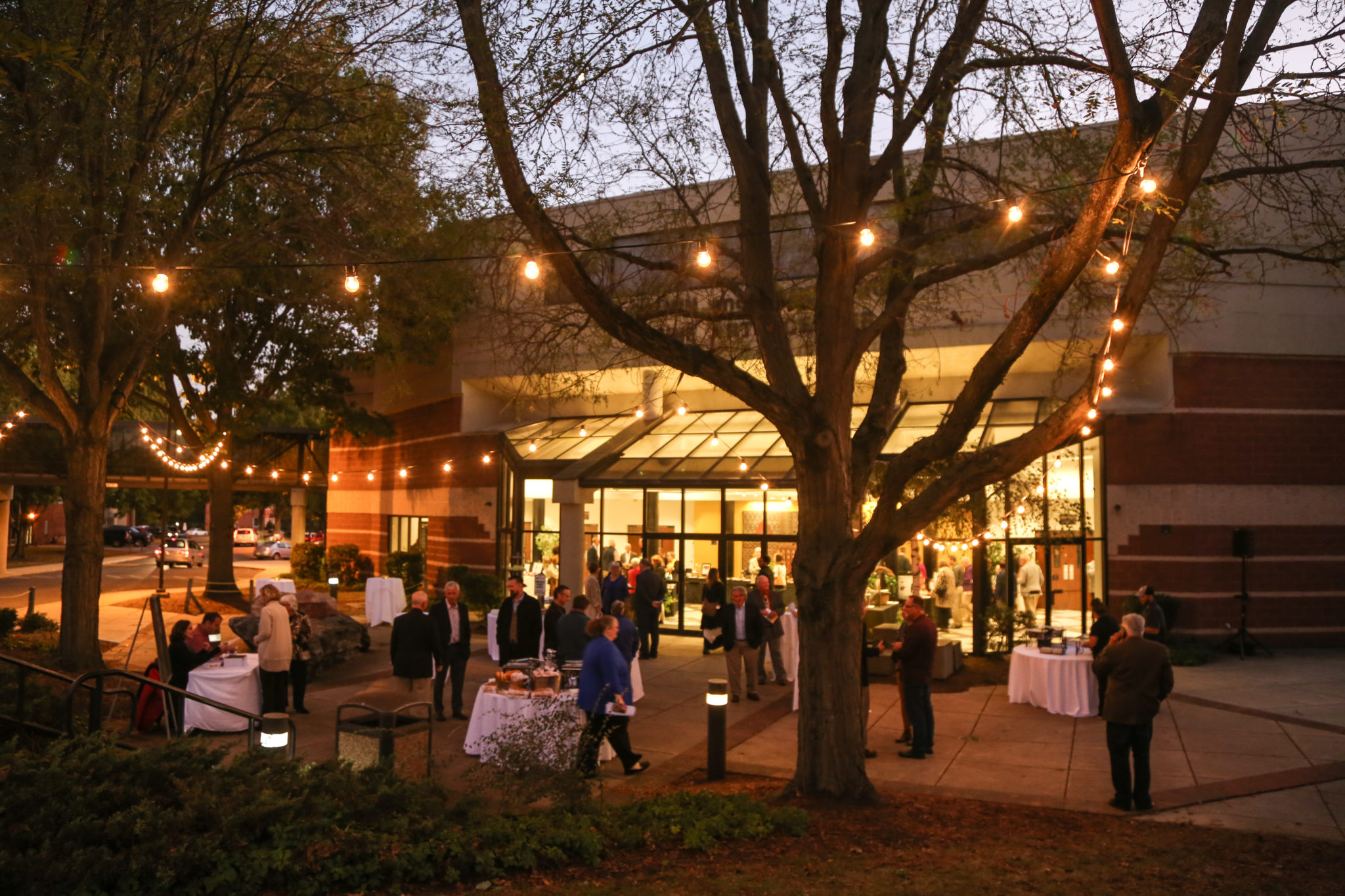 Fine arts center entrance at twilight with event set up outside