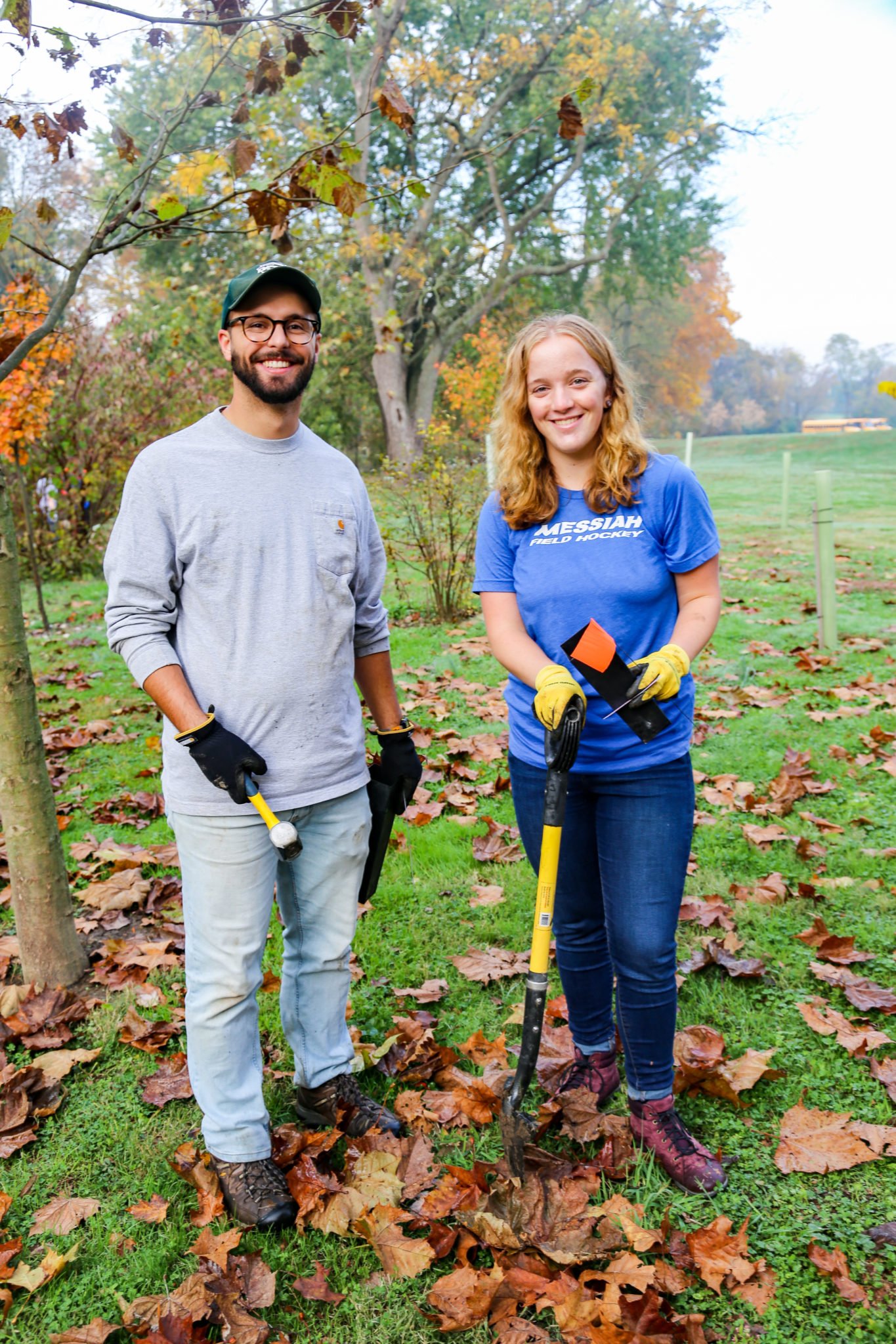 student planting trees on mill stream