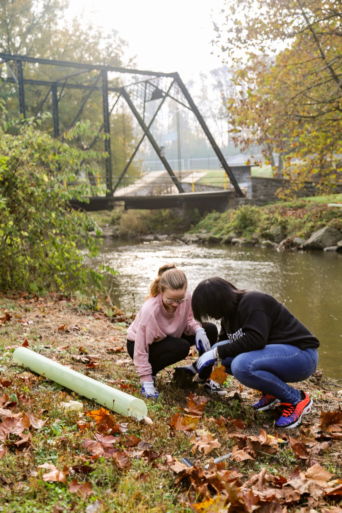 student planting trees on mill stream