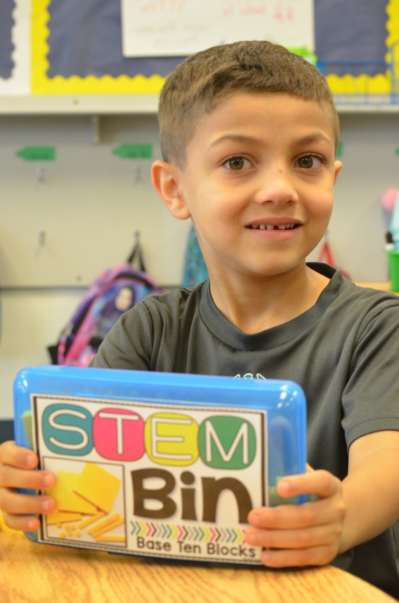 student holding stem bin