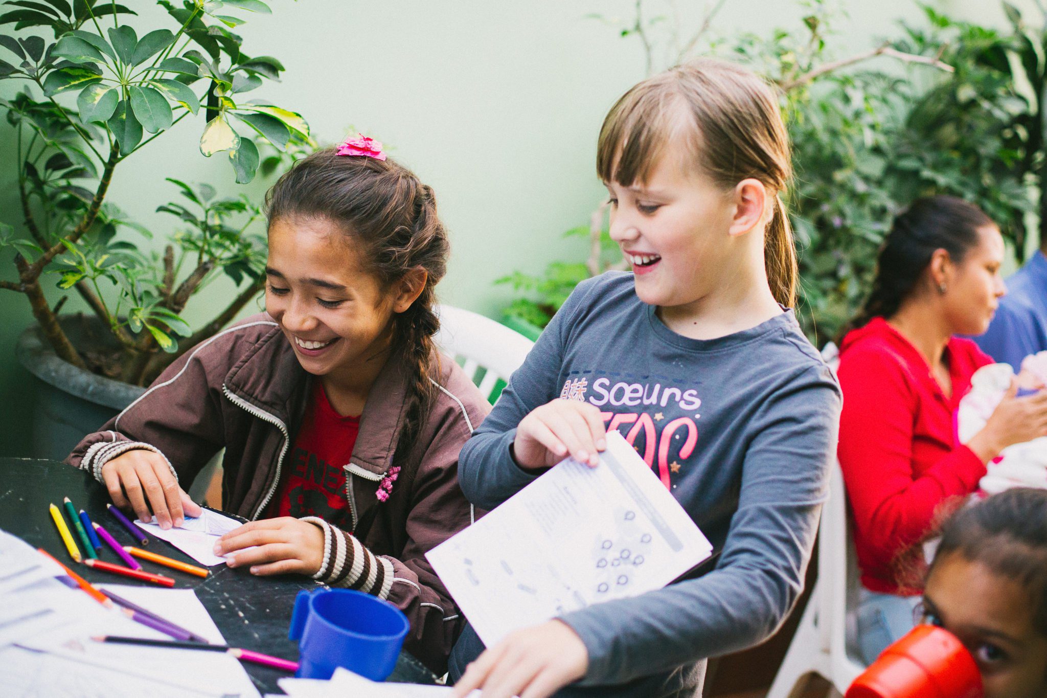 students smiling & coloring