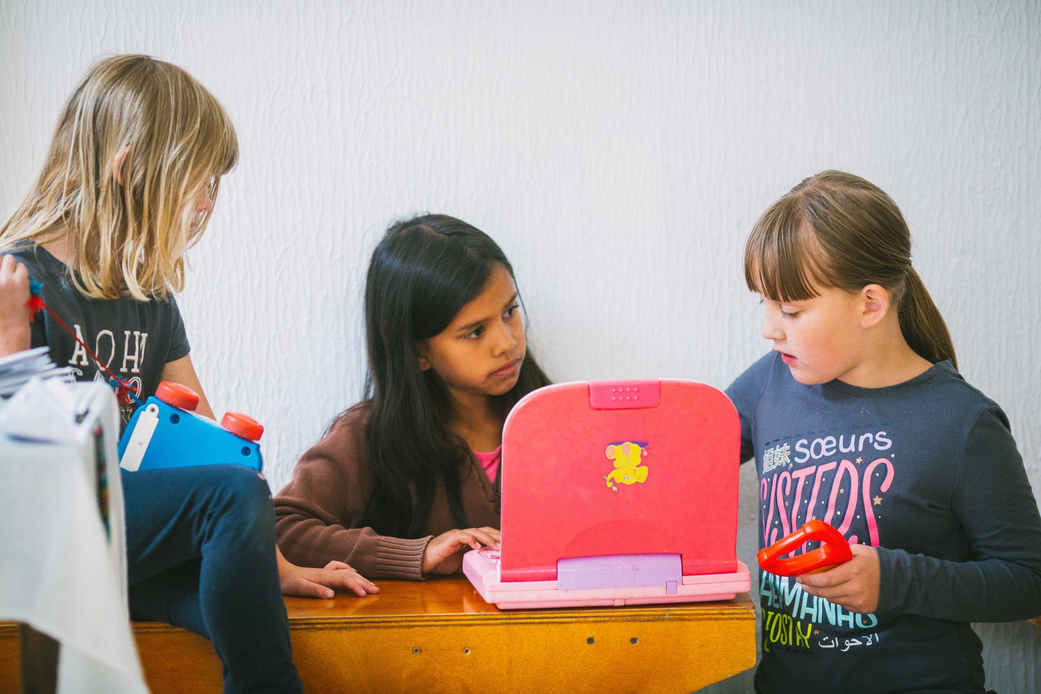 students gathered around a laptop