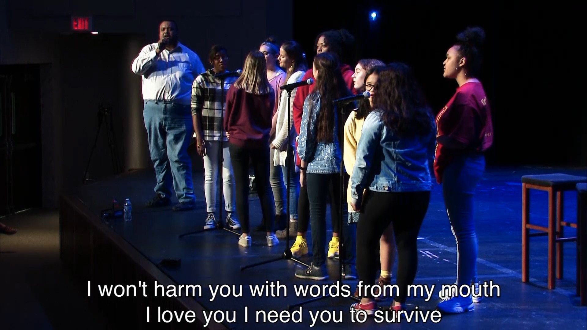 students singing on stage