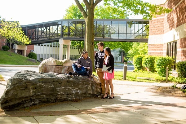 students sitting on rock