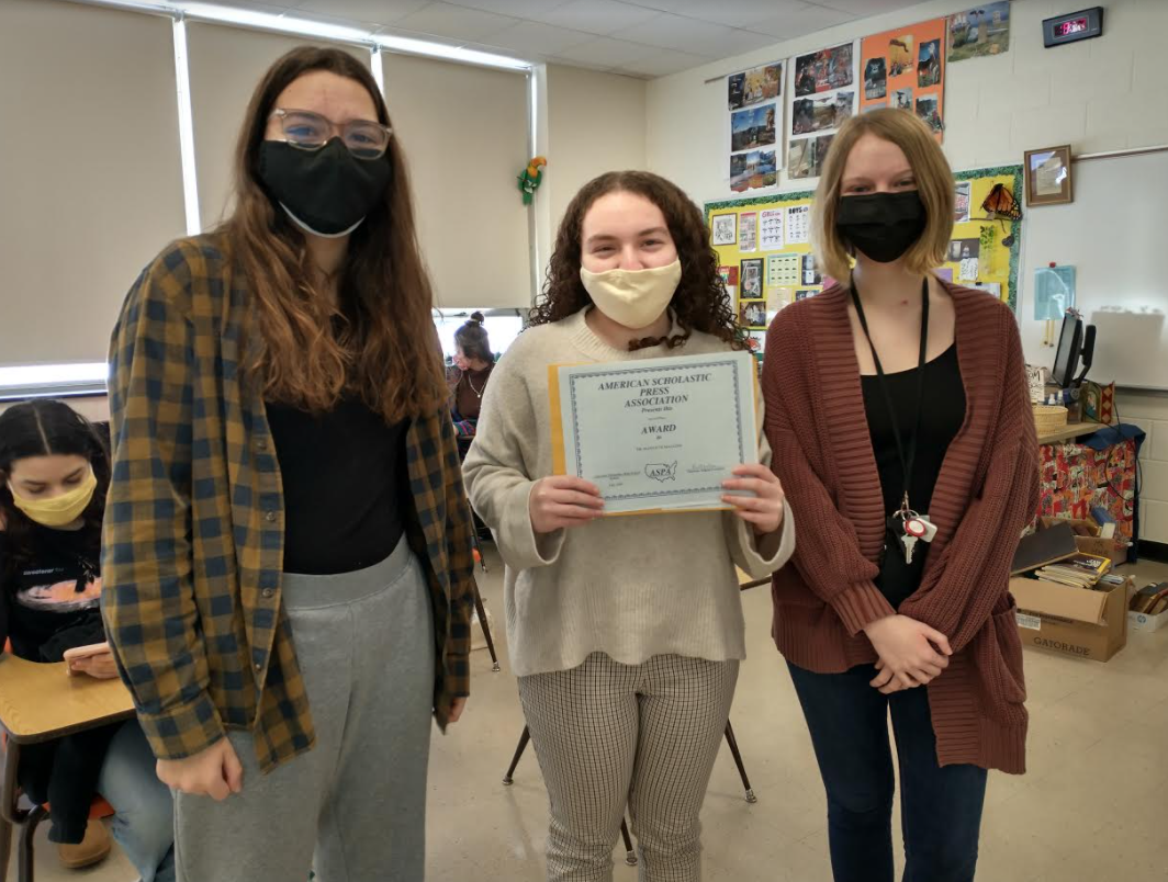 american scholastic press association award with 3 students