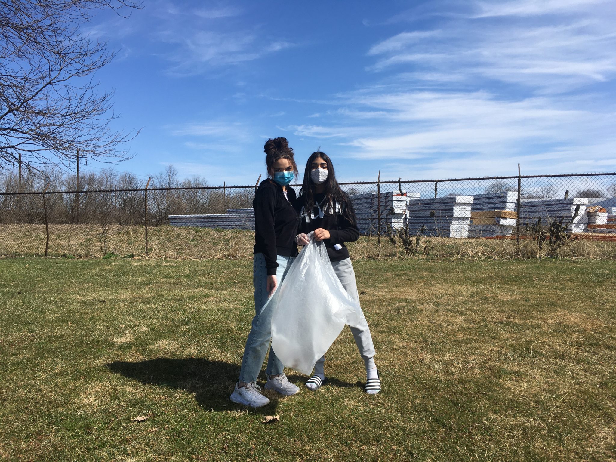 students outside cleaning up the campus