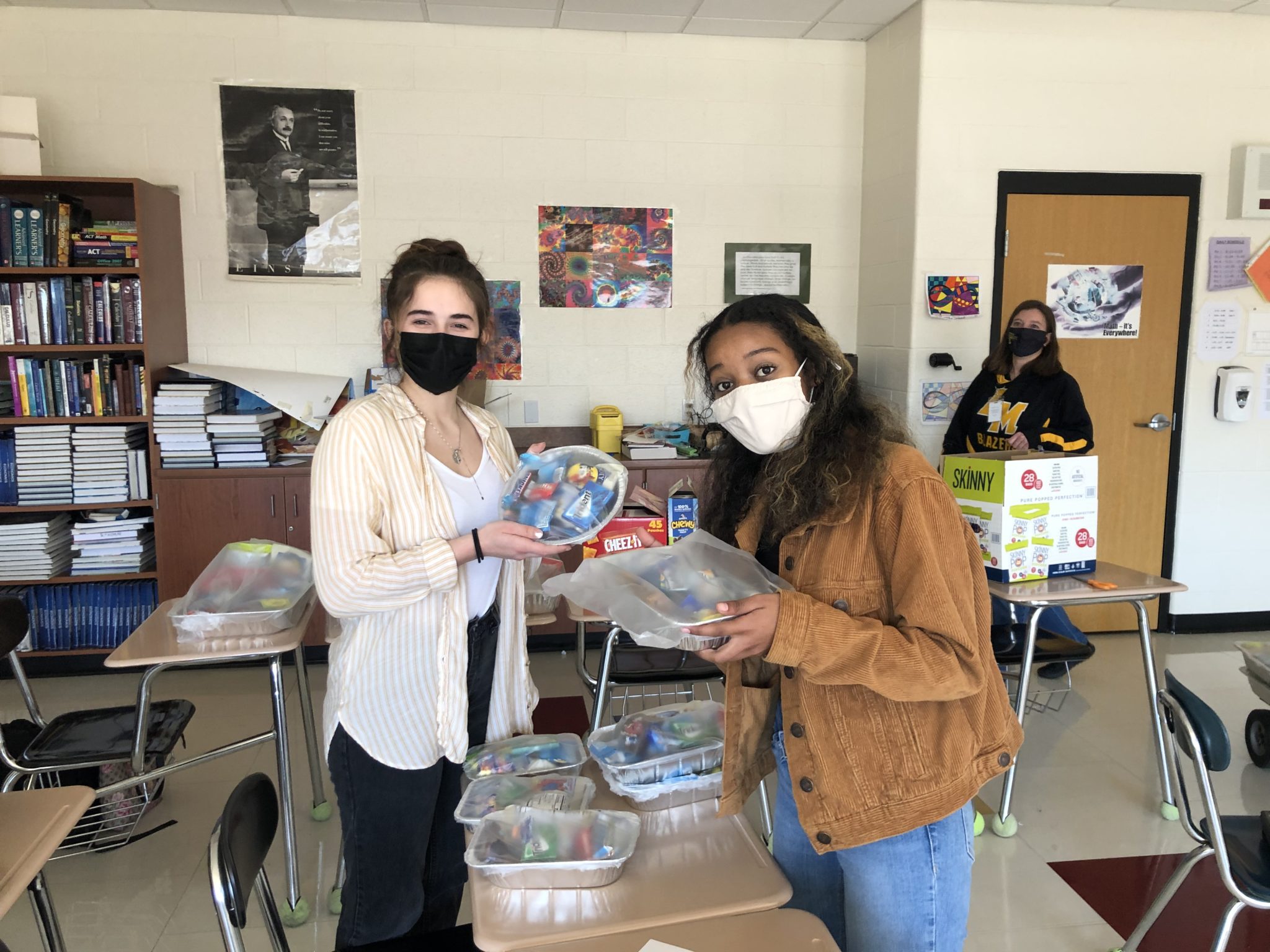 students holding care packages