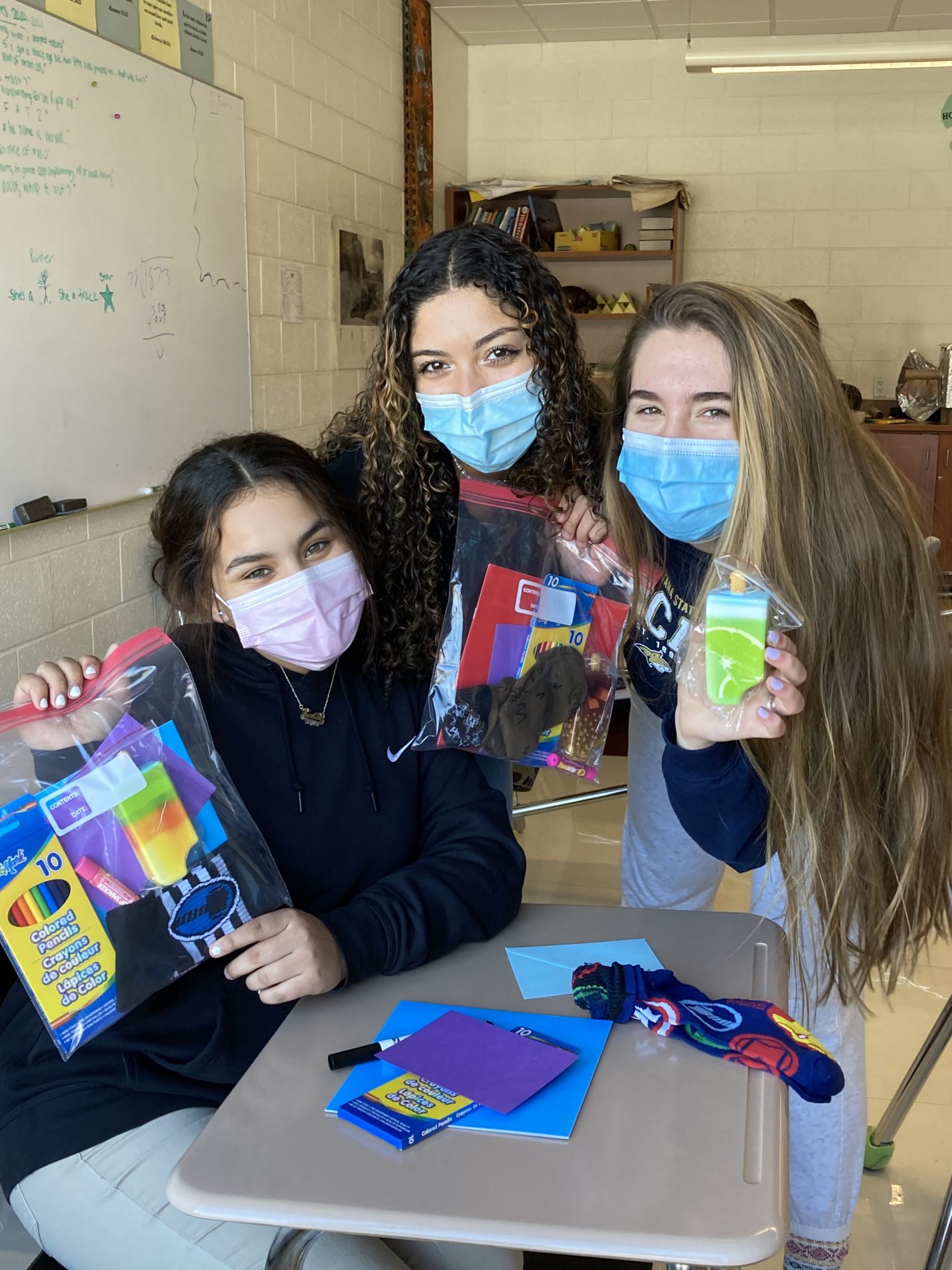 students holding care packages