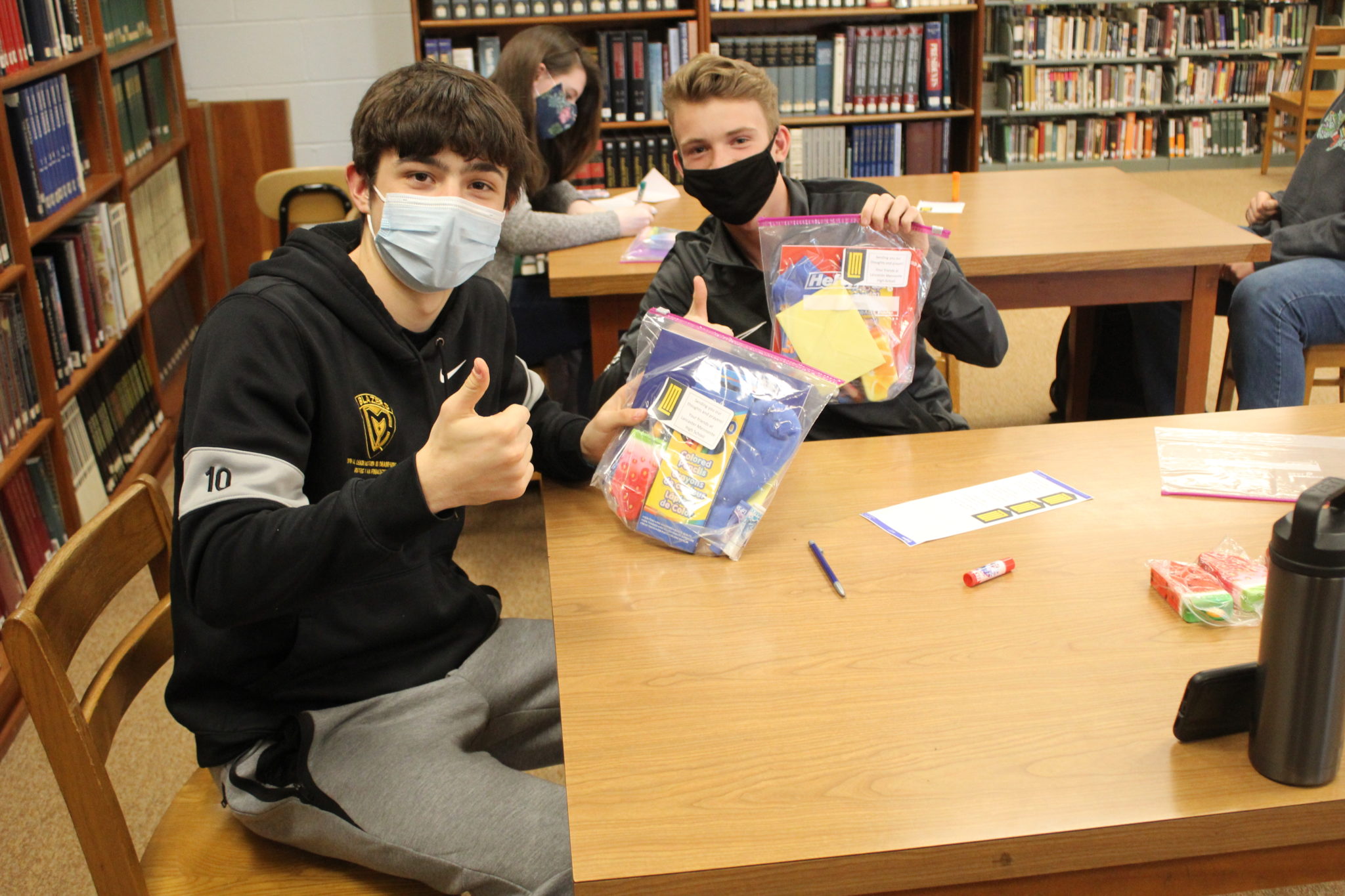 students holding onto care packages