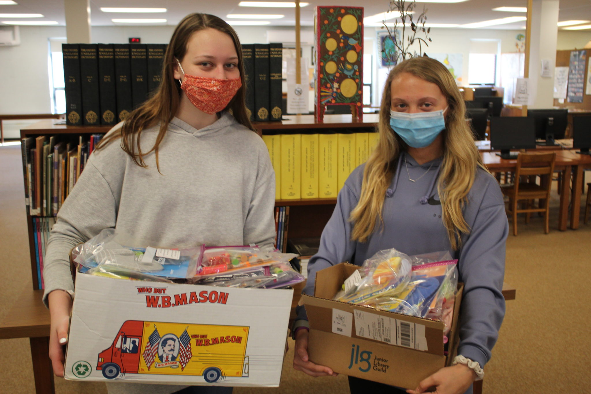 students holding boxes full of care packages