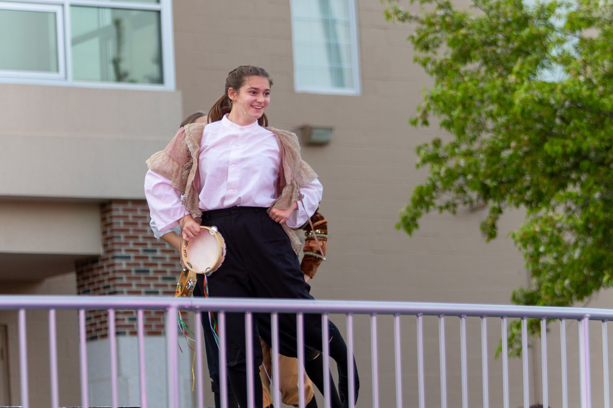 student acting during the performance of all the worlds a stage