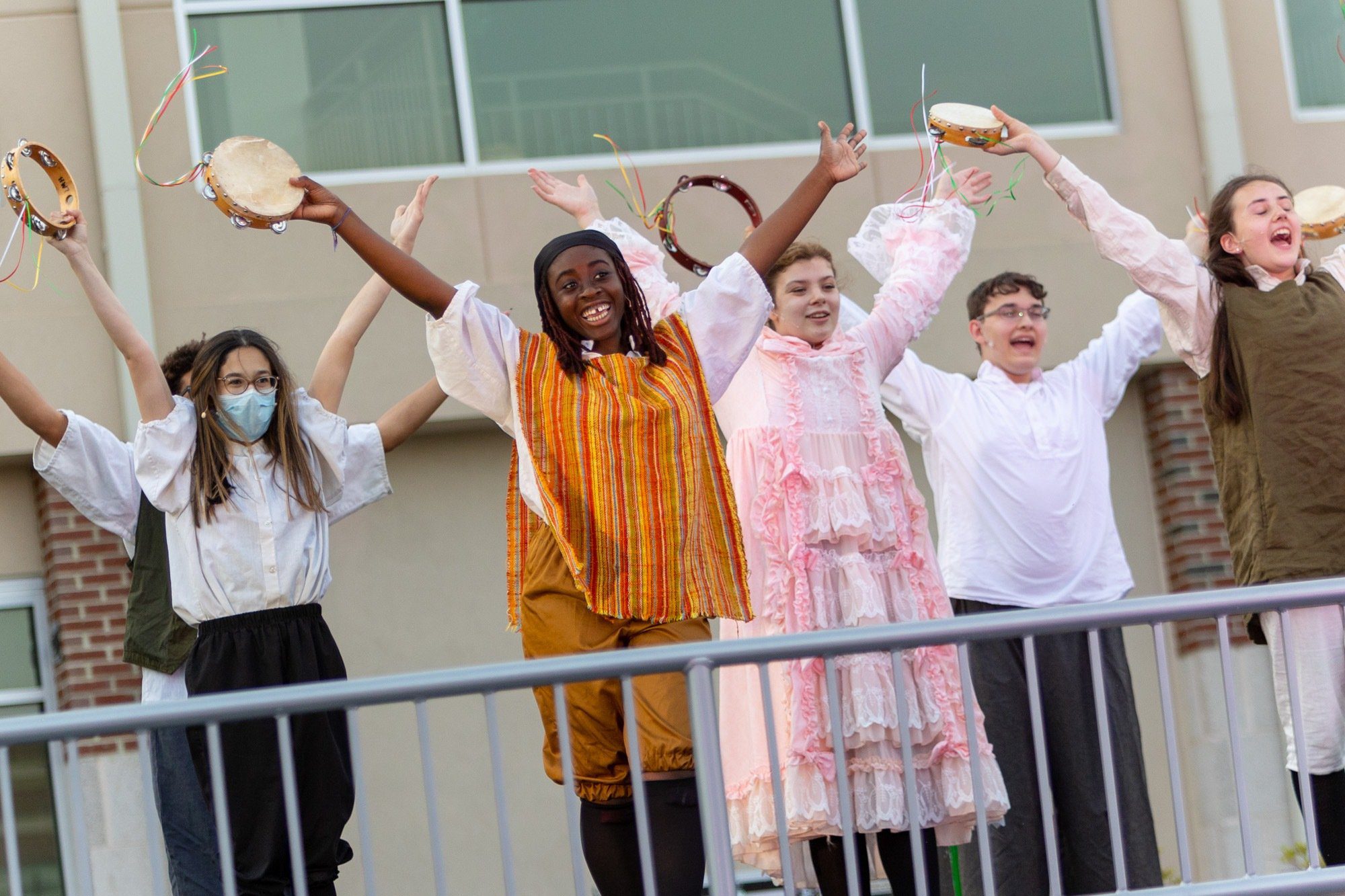 students acting and dancing during the performance of all the worlds a stage