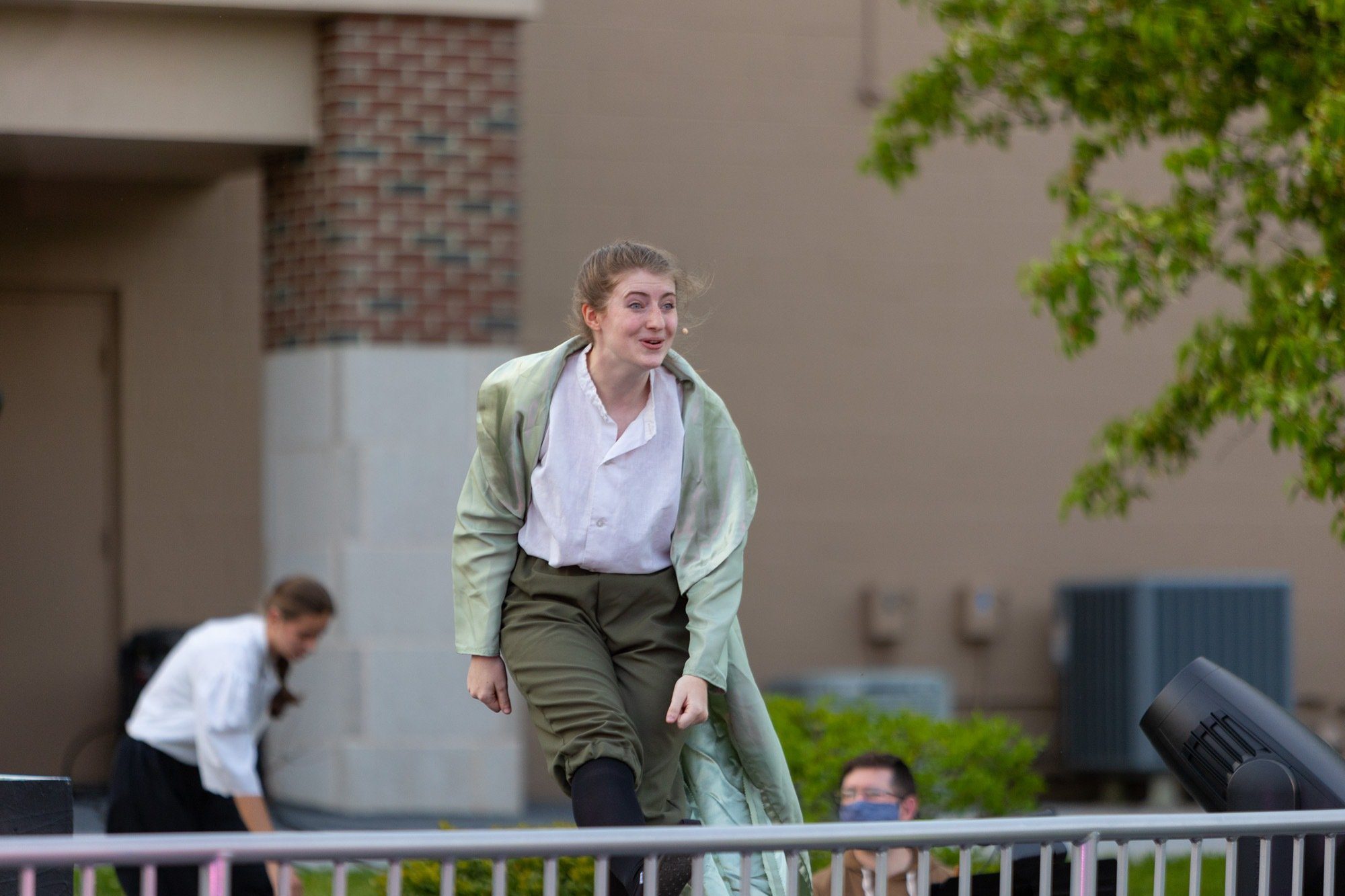 student acting during the performance of all the worlds a stage