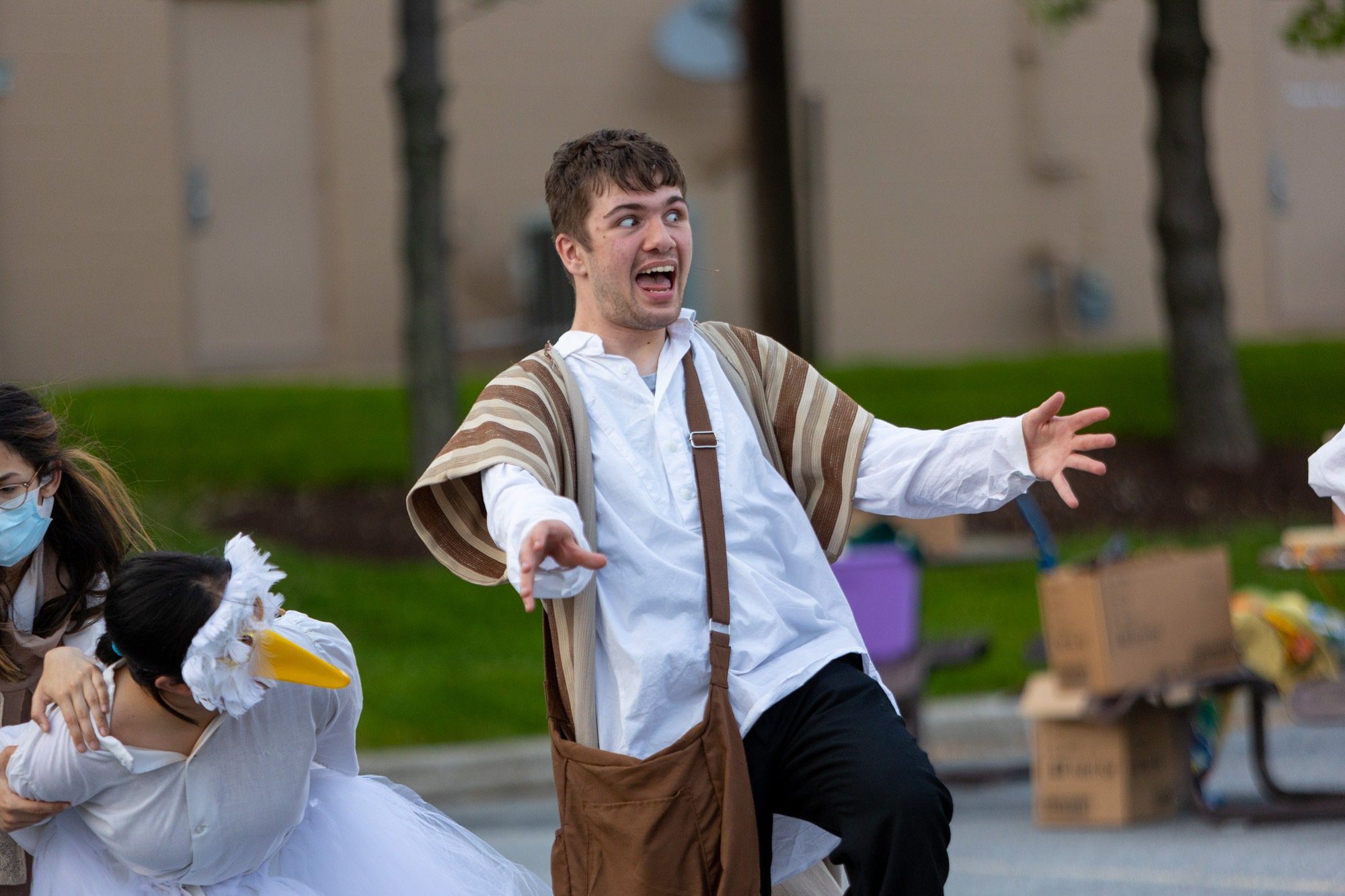 student acting during the performance of all the worlds a stage