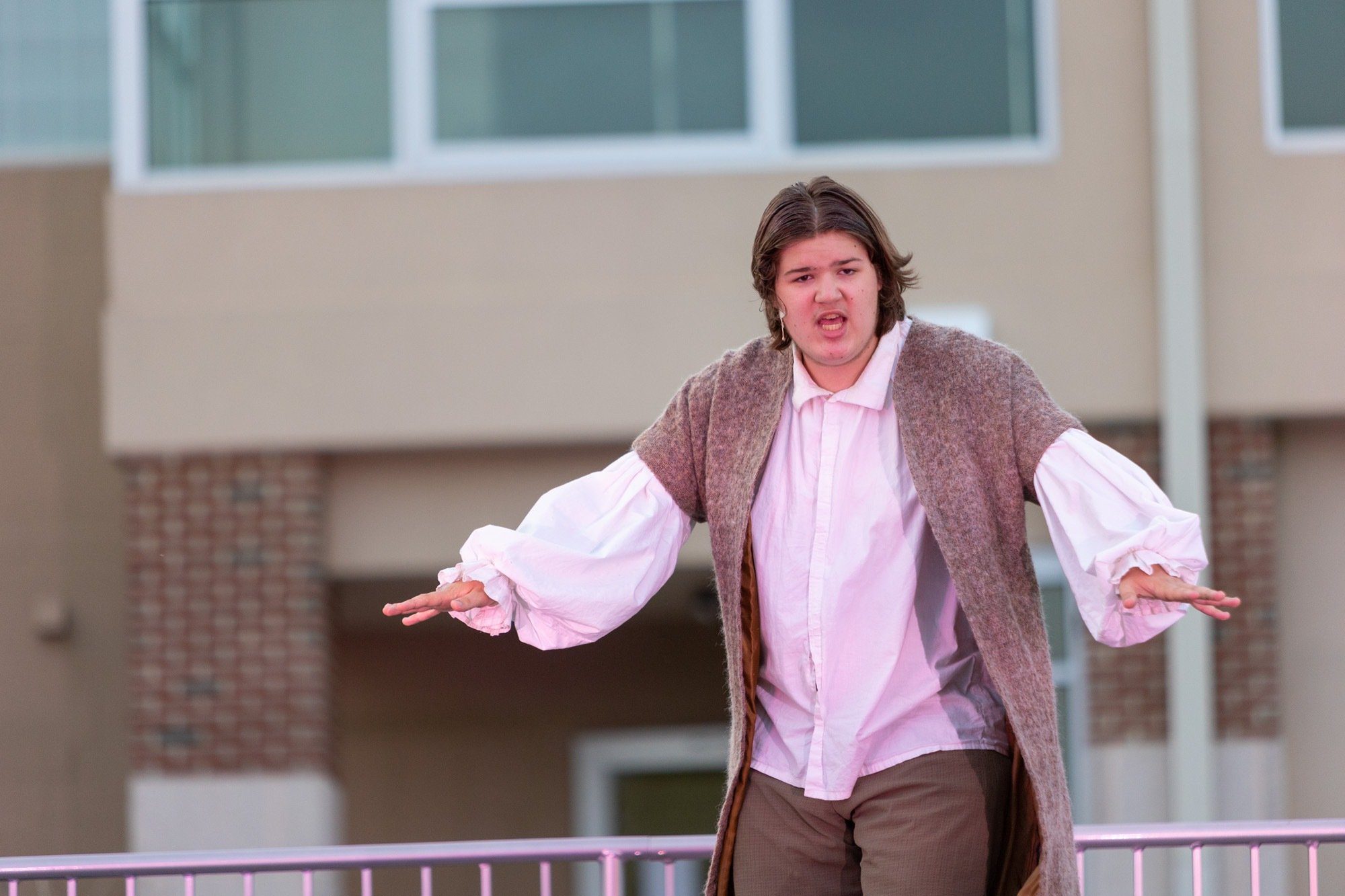 student acting during the performance of all the worlds a stage