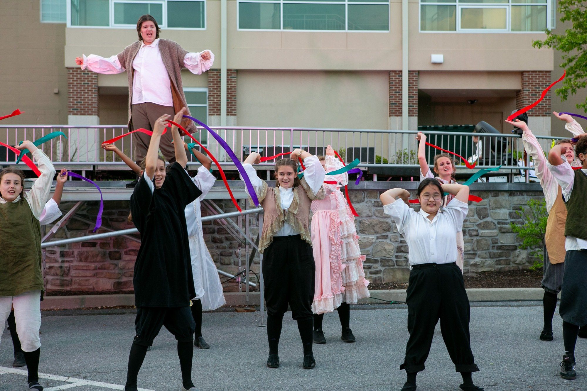 students dancing and acting during the performance of all the worlds a stage