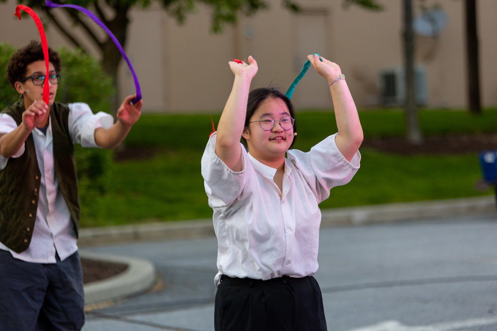 student dancing during the performance of all the worlds a stage