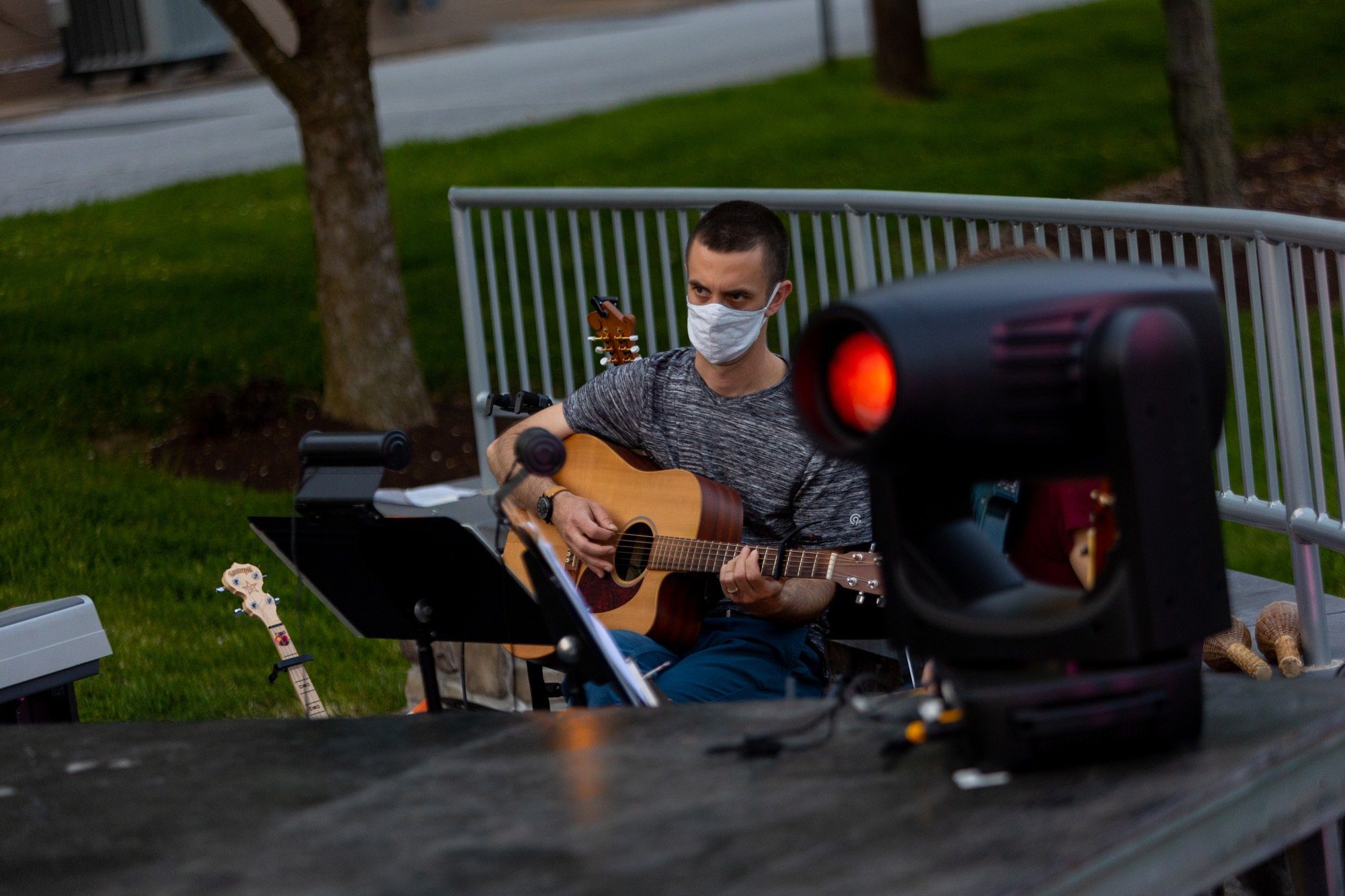 crew member playing guitar during all the worlds a stage