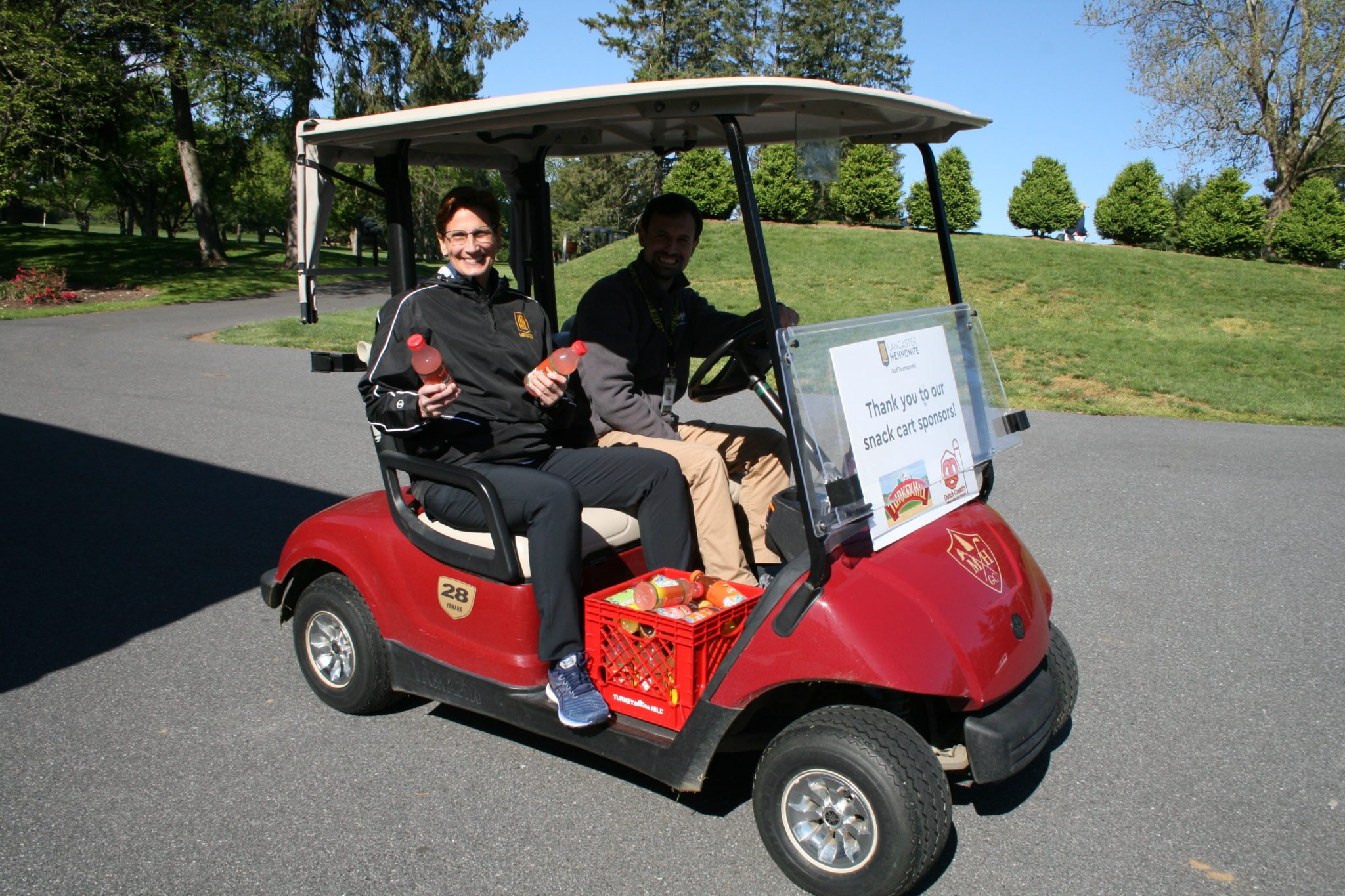 Dr. T & jon heinly handing out refreshments at the golf tournament