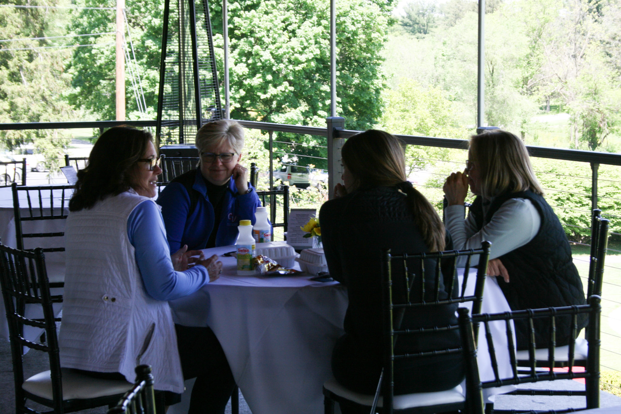 4 women talking around table