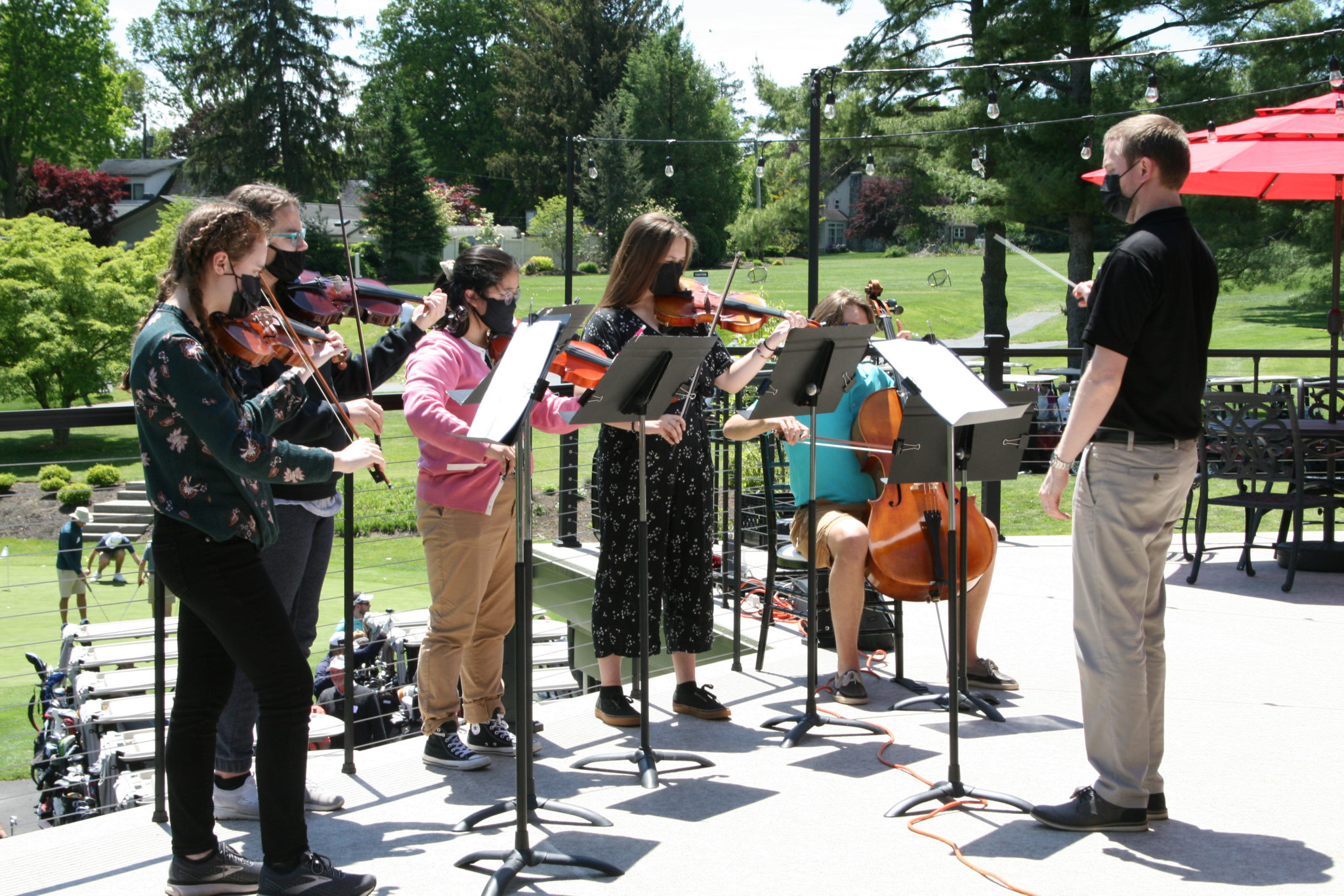 orchestra students playing at golf tournament