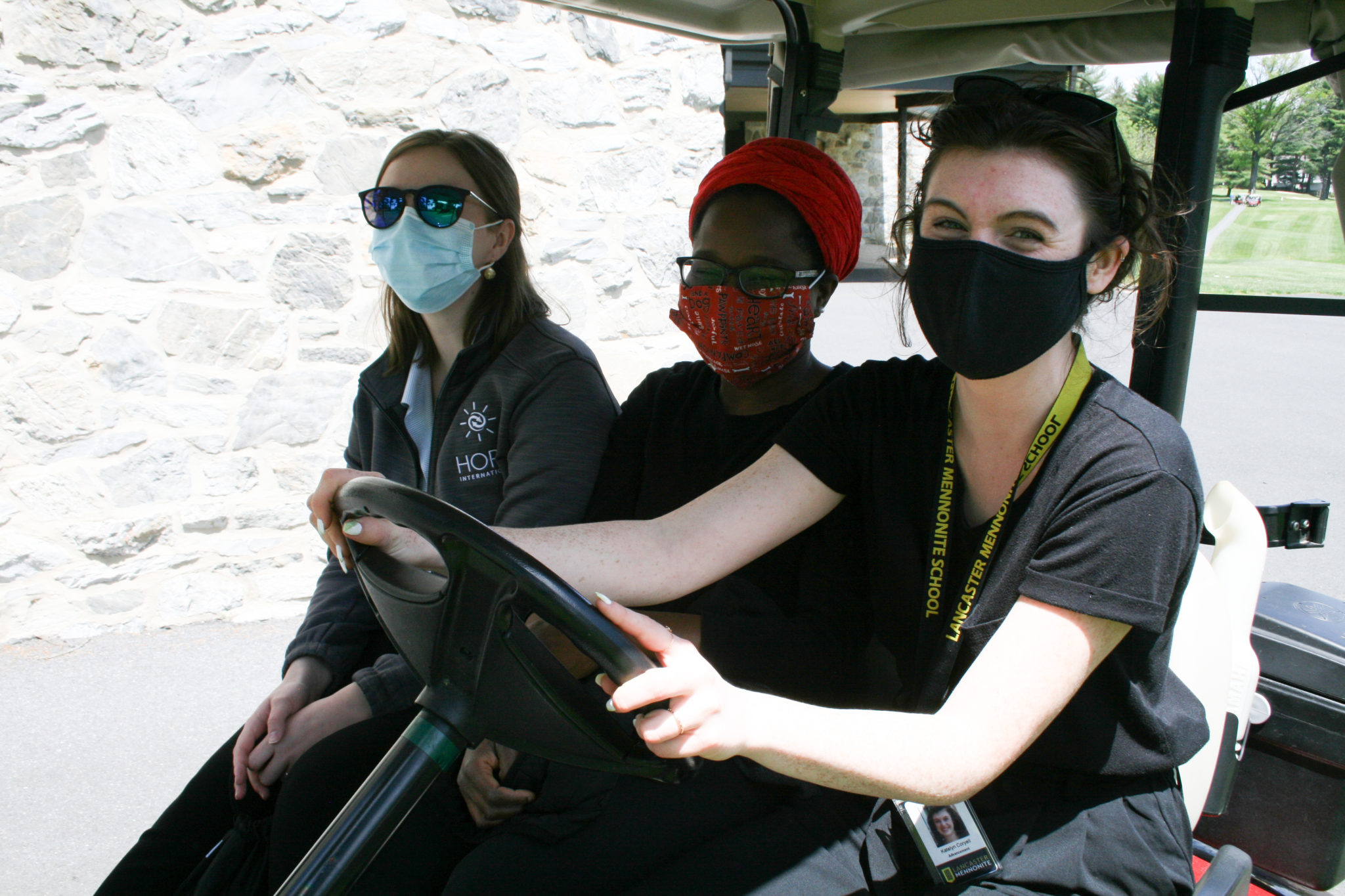 3 women on golf cart