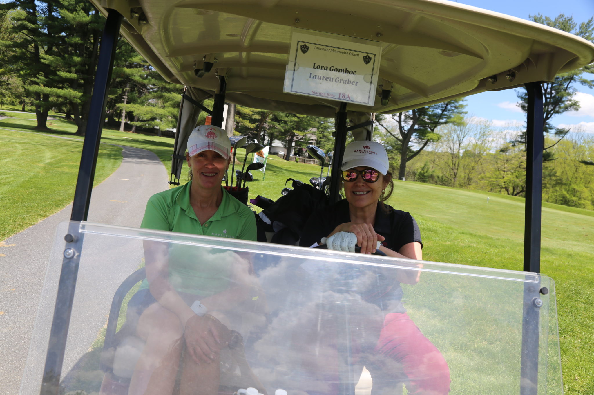 2 women on golf cart