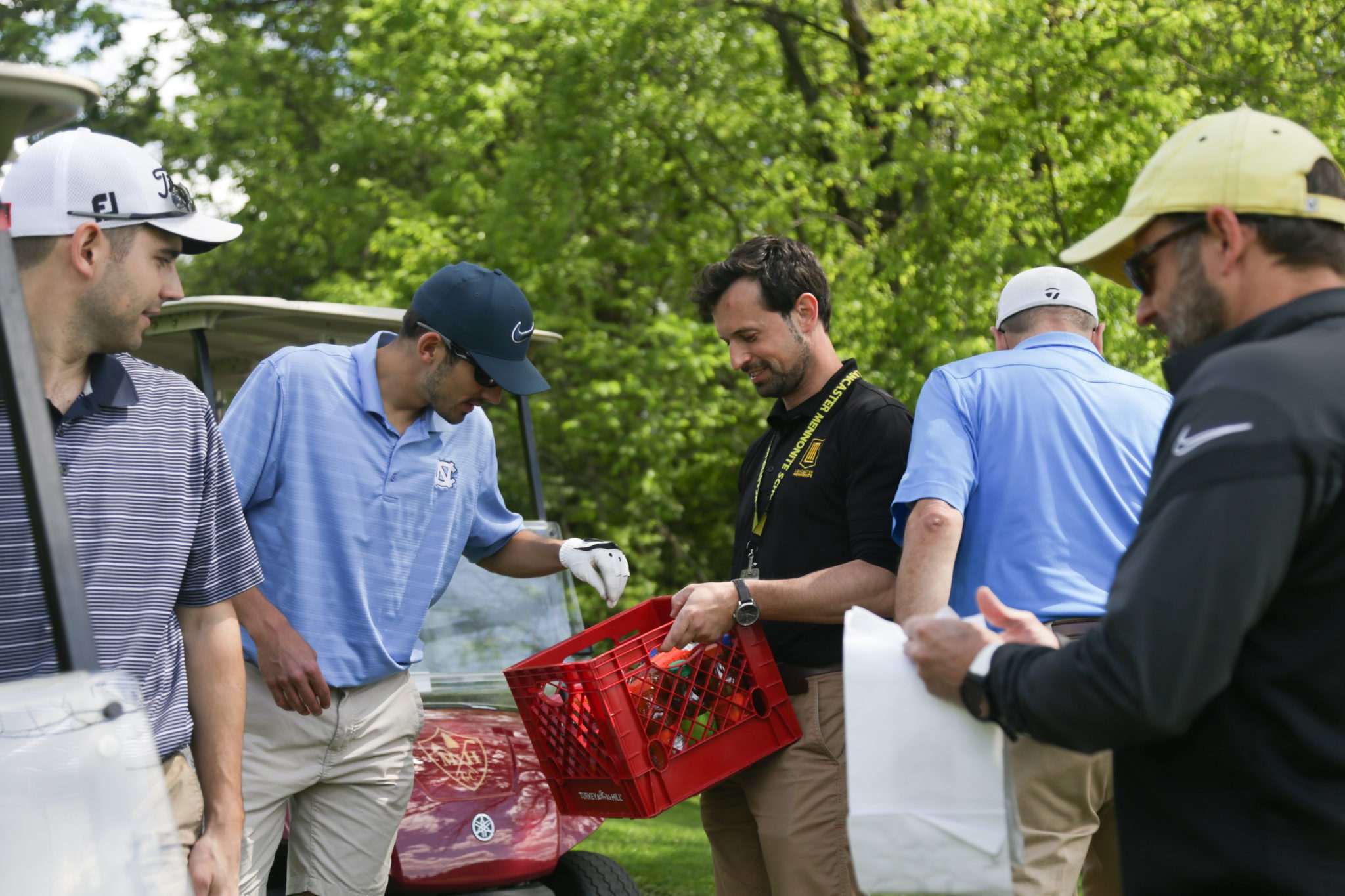 jon heinly handing out drinks at LM golf tournament