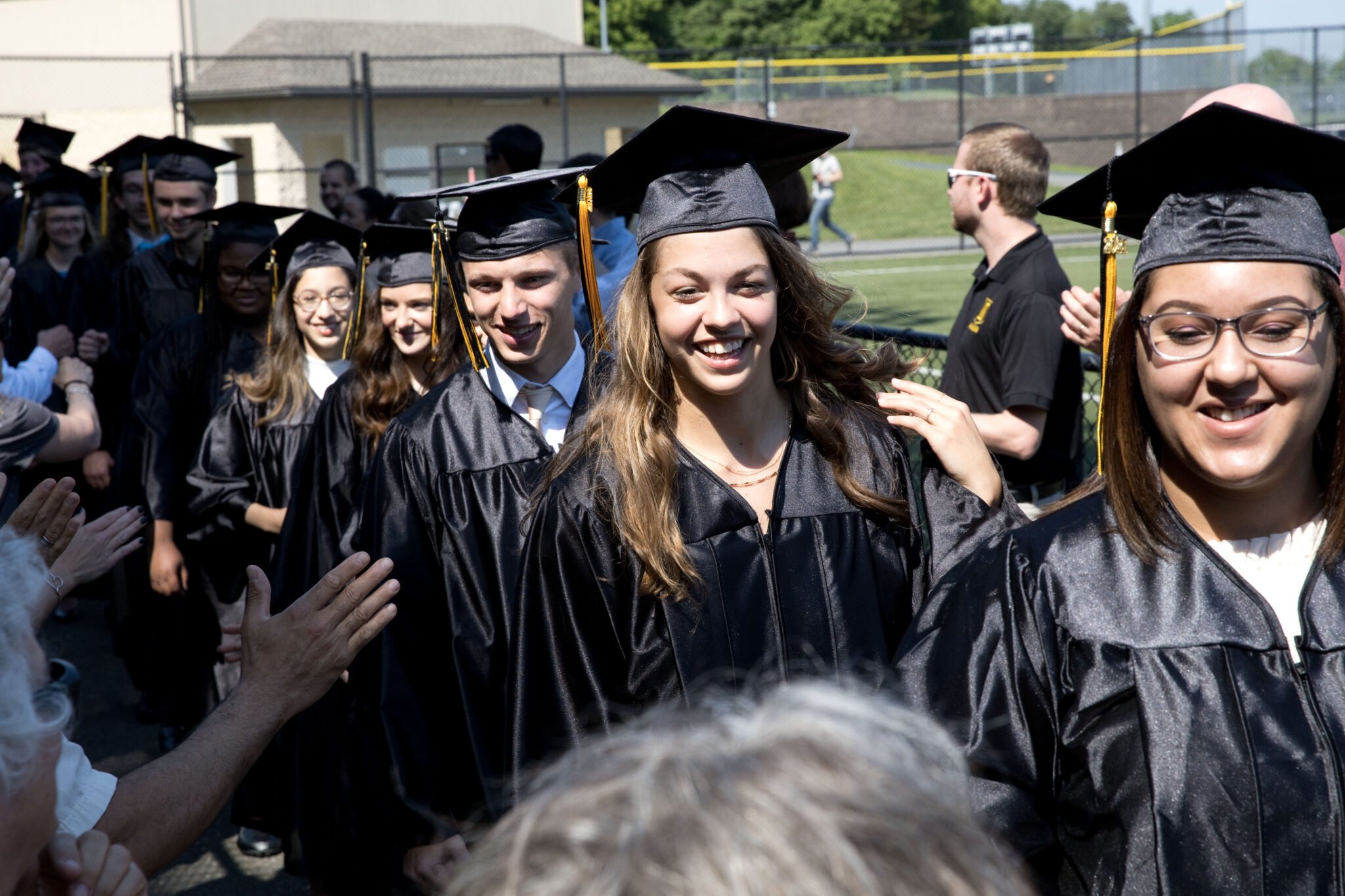 students walking in to graduation
