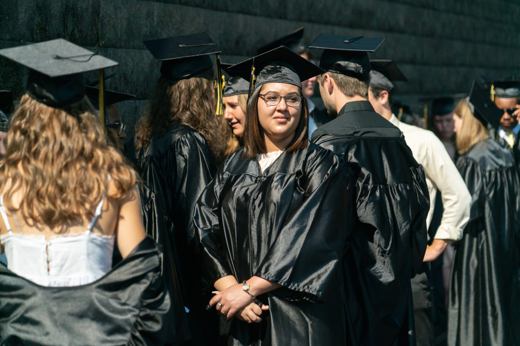Graduates in caps and gowns waiting