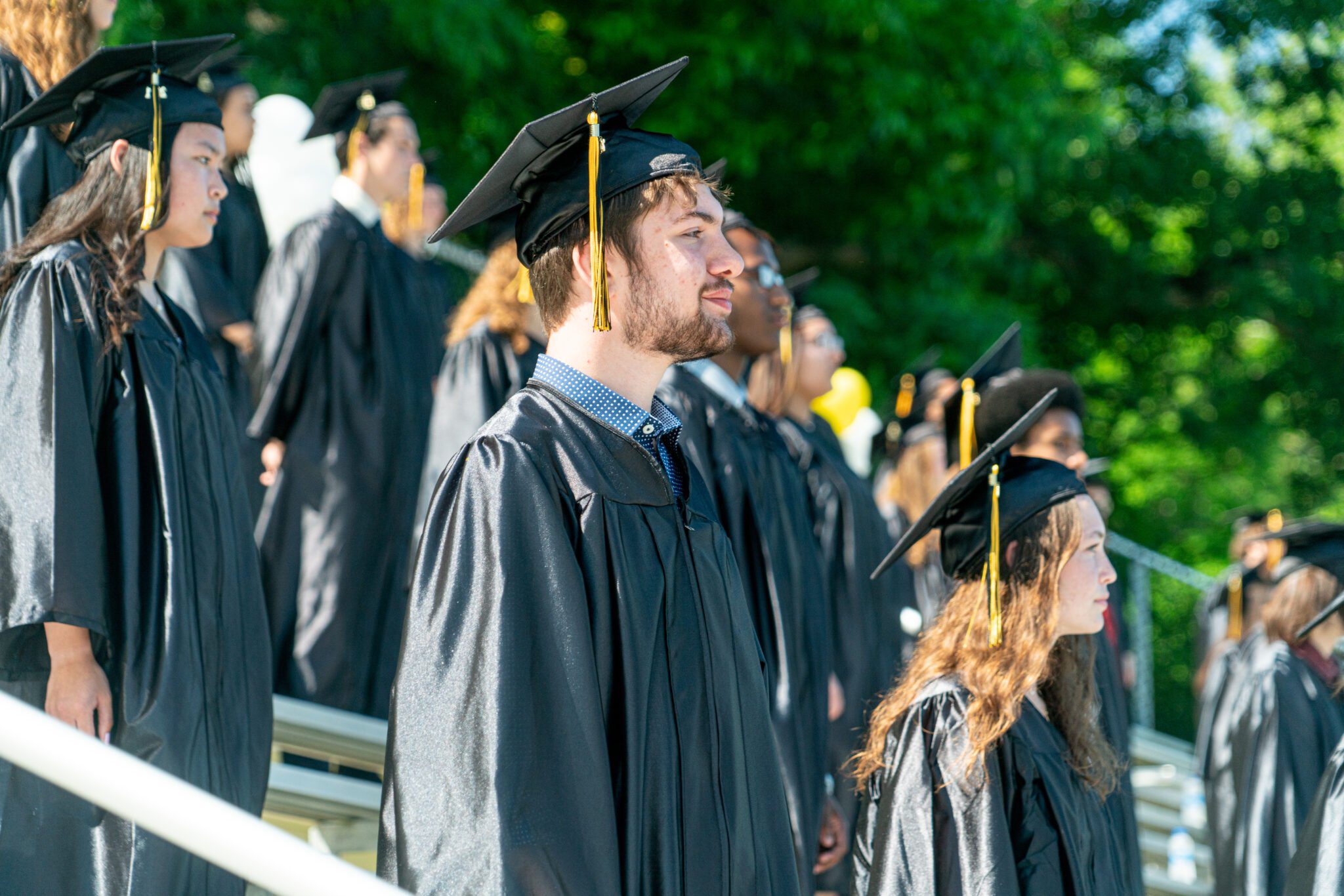 graduates sitting in bleachers at commencement