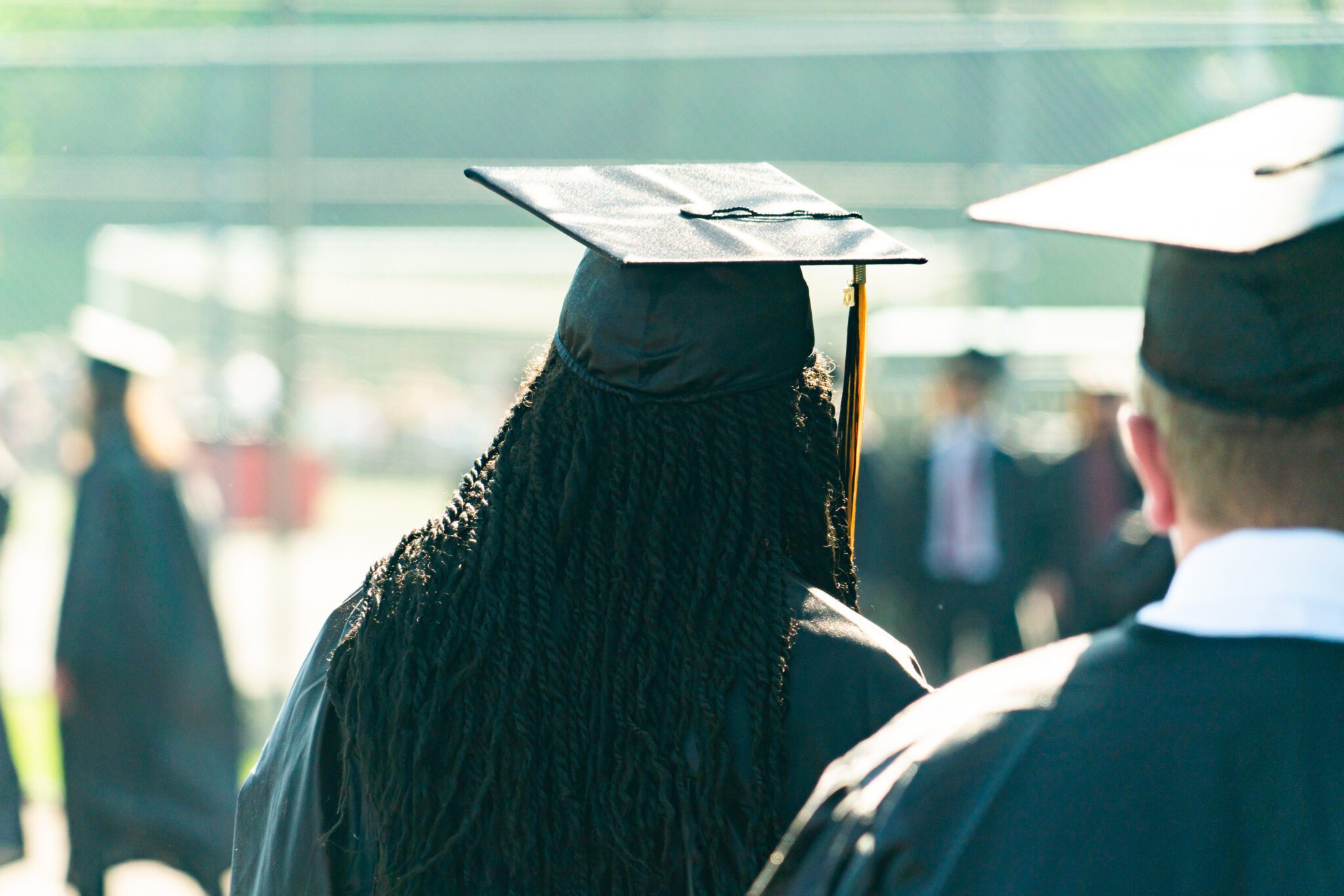 Graduate in cap in gown from the backside