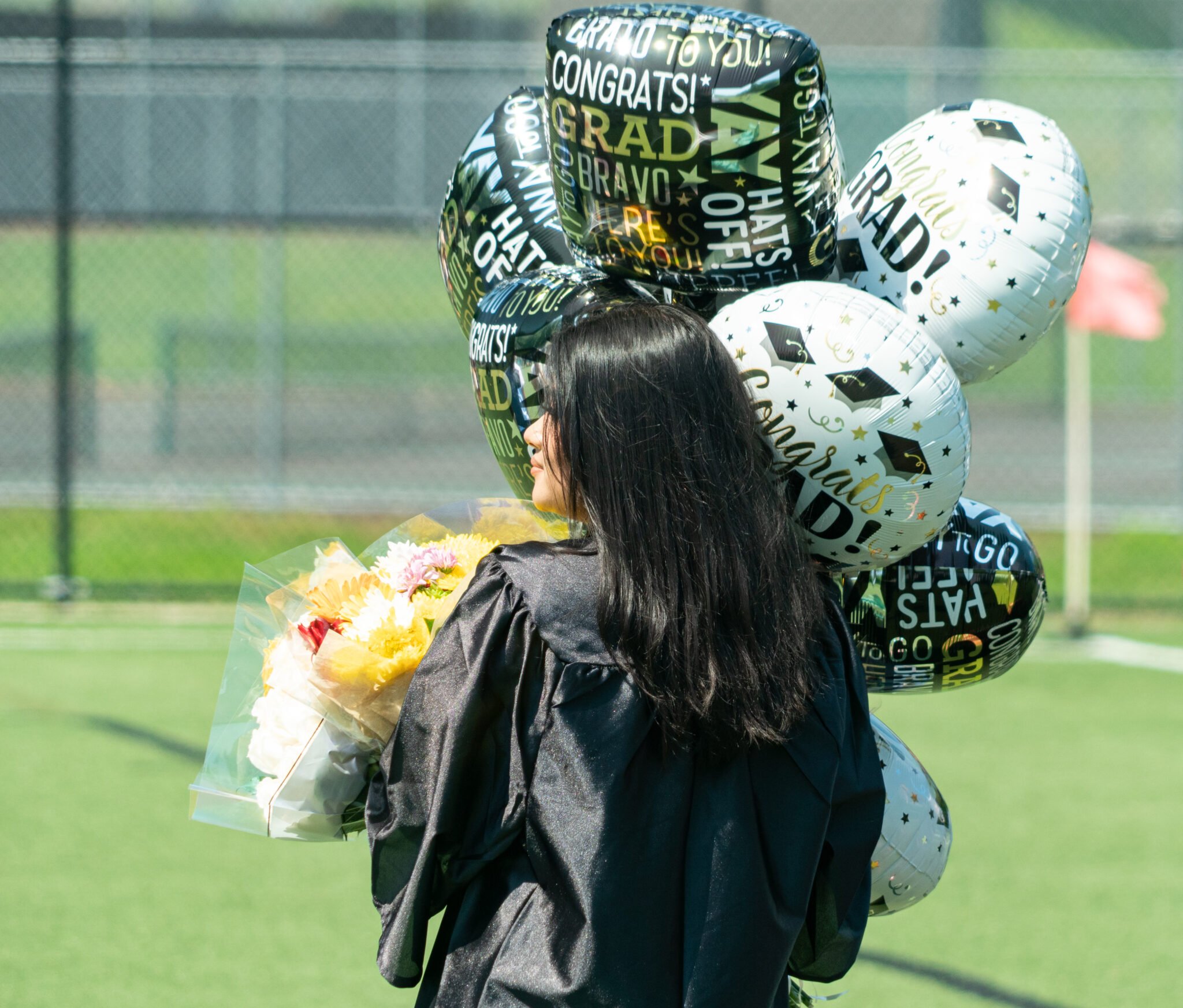 graduate with balloons