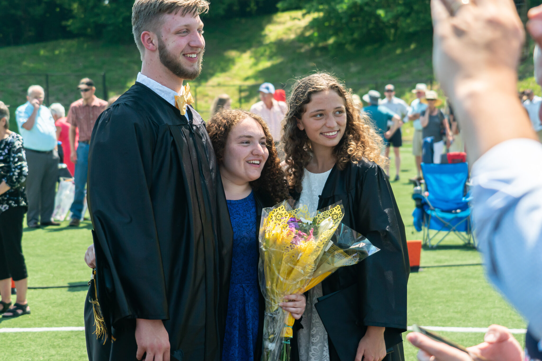 graduates pose after ceremony in gowns