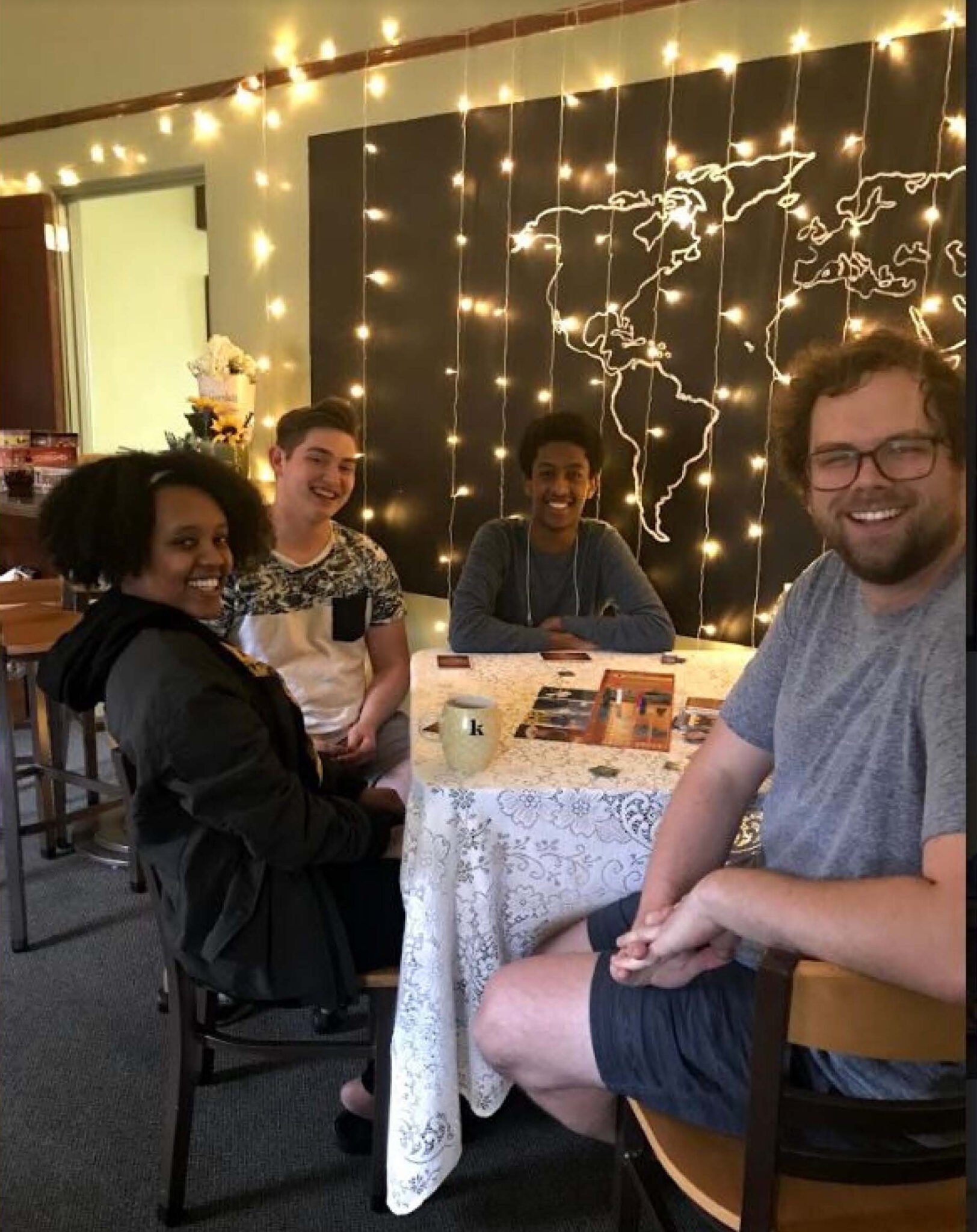 three people sitting around a table